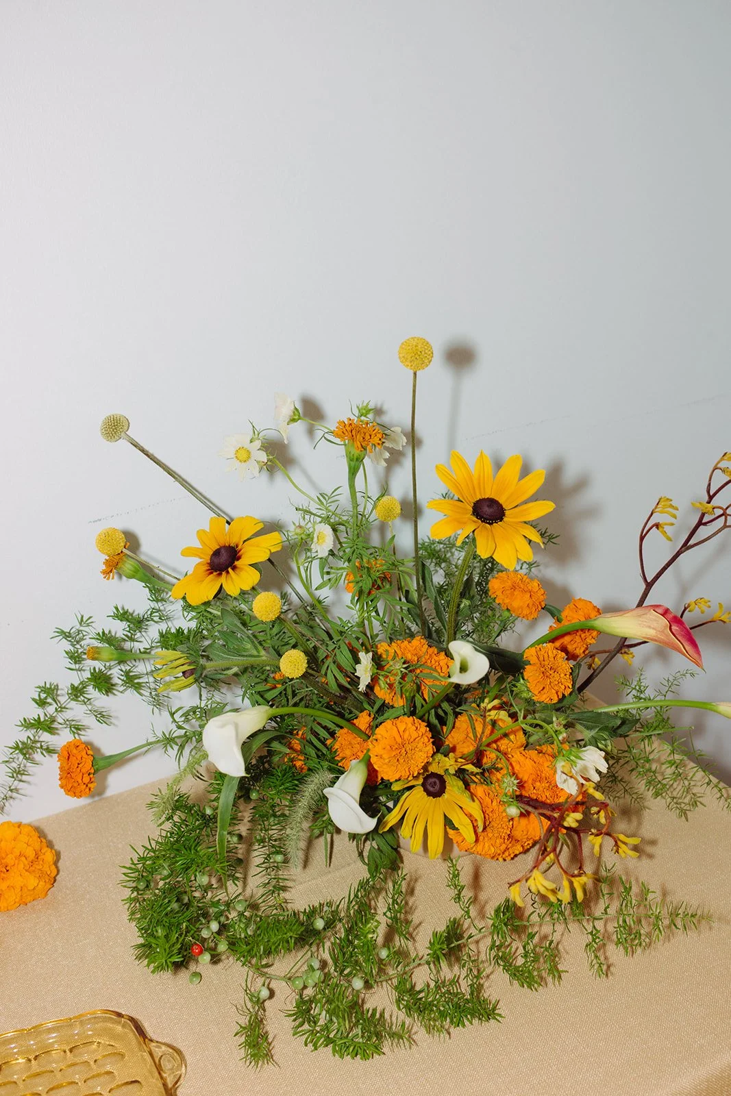 Modern september wedding reception orange and yellow color palette floral pedestals marigolds calla lilies repurposed ceremony altar arrangements the cottage rose kansas city wedding florist crossroads hotel kansas city wedding