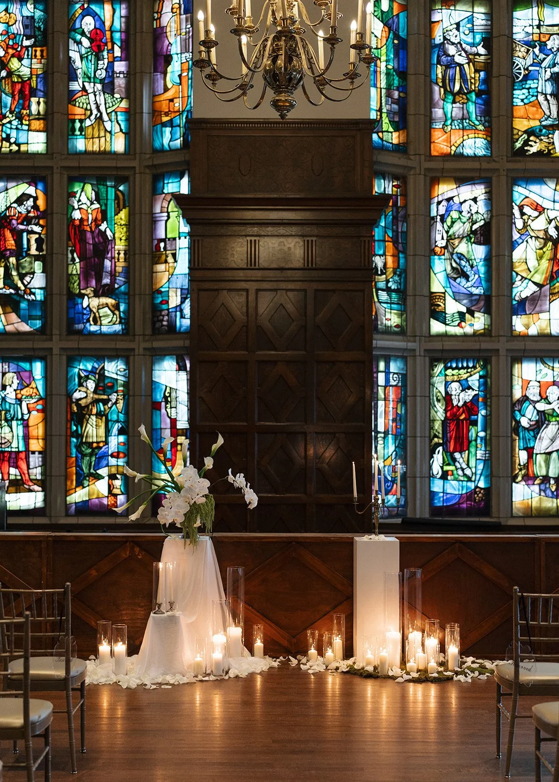 Modern chic november fall wedding downtown hotel kansas city rose petals orchids calla lilies amaranth wedding ceremony arrangement pedestal candles fabric altar installation the cottage rose kansas city wedding florist crossroads