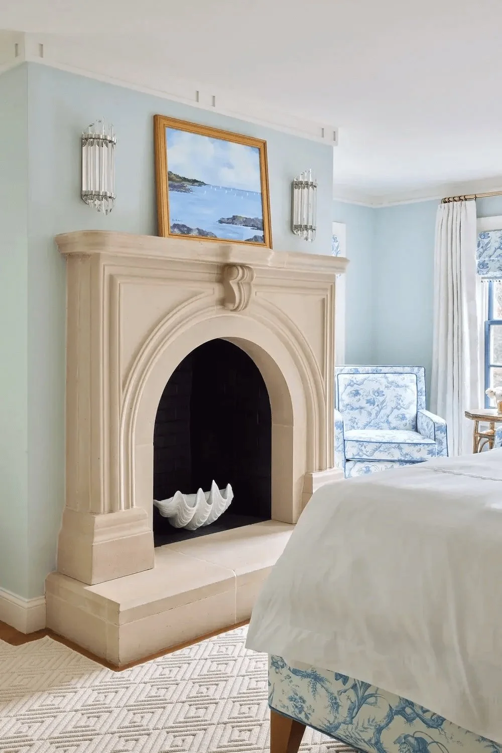 New England luxury bedroom in blue and white with limestone fireplace and custom fabricsusomt bedding