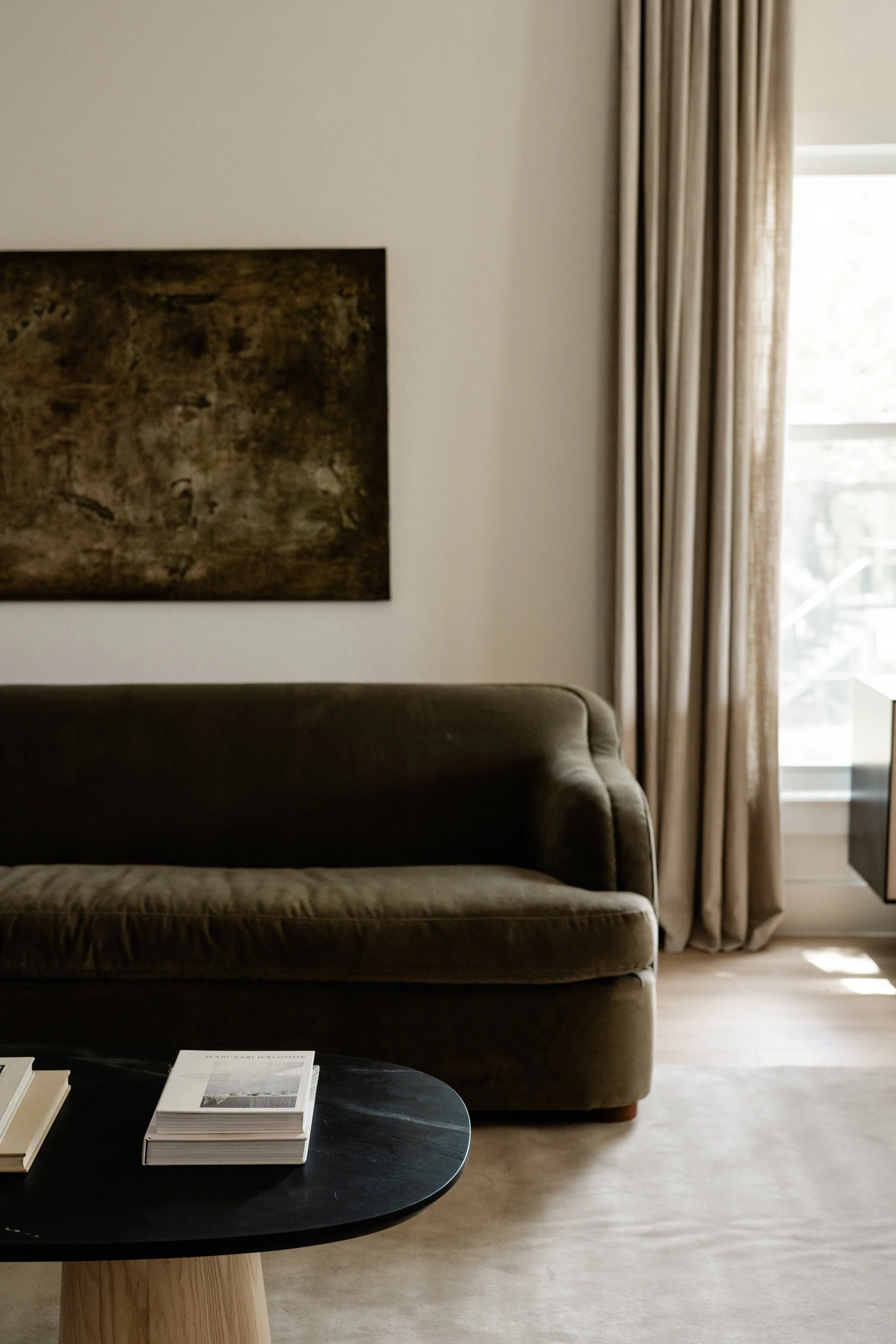 timeless-neutral-earthy-living-room-brown-green-velvet-sofa-linen-curtains-austin-house-franc.jpg