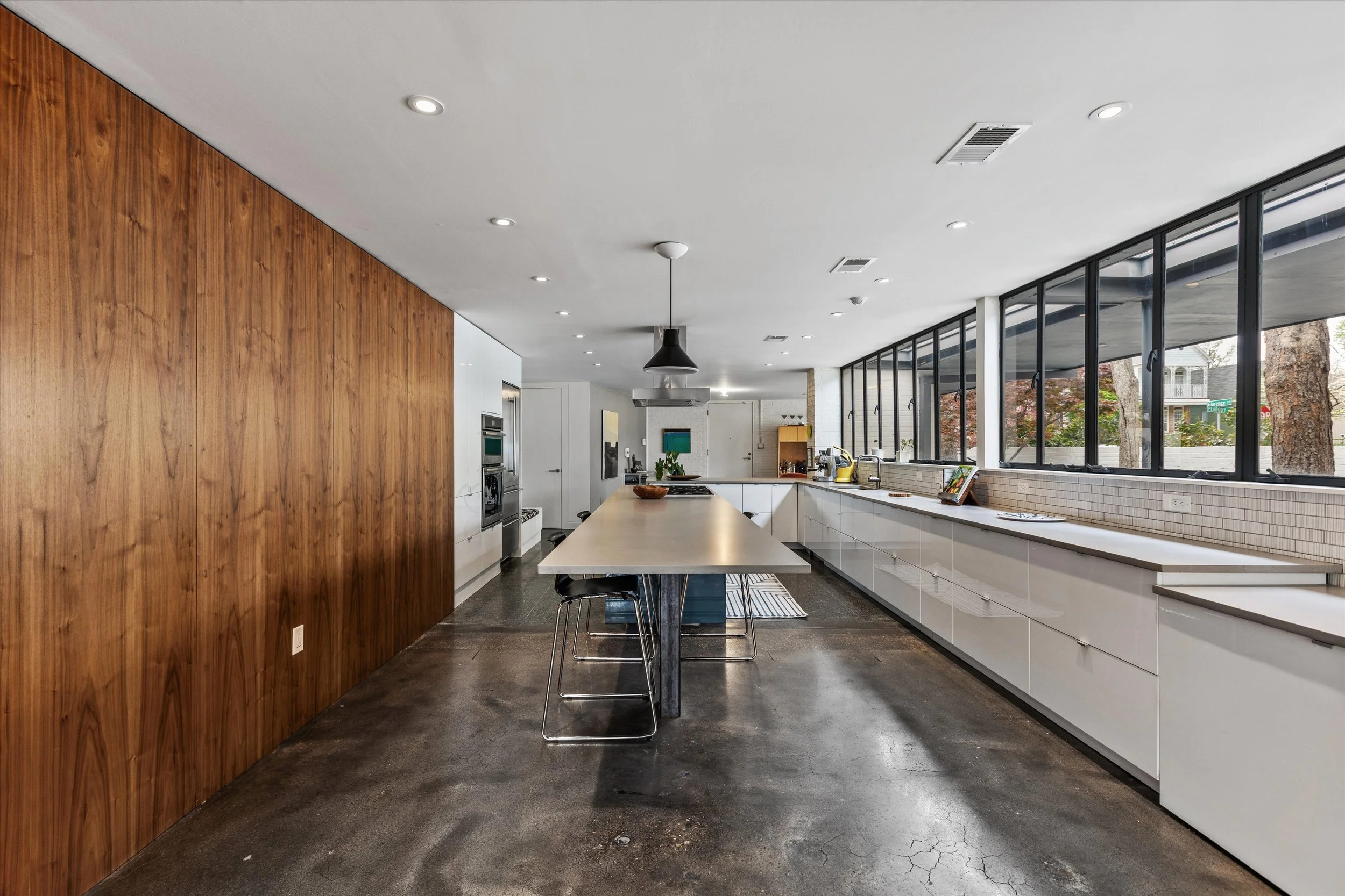 Warm walnut contrasts with sleek cabinets