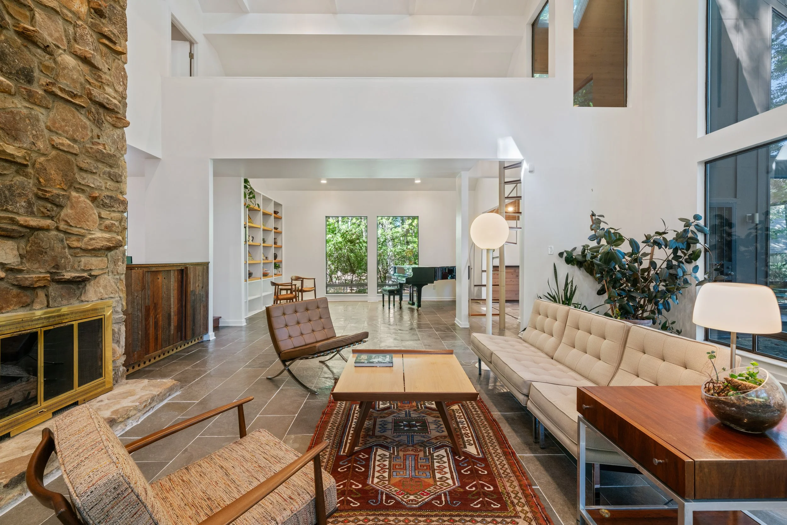 Late modern home with high ceilings and stone fireplace