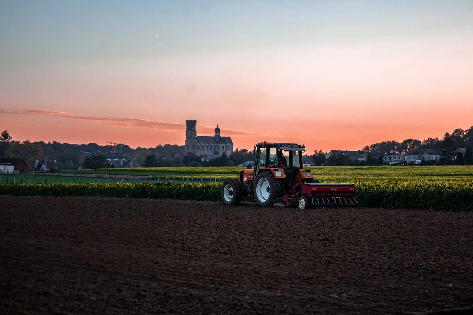 orange-tractor-planting-field.jpg