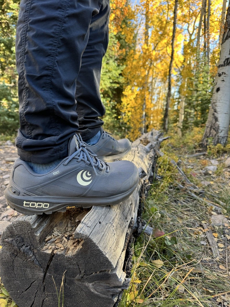 woman wearing topo hiking shoes hiking colorado trails