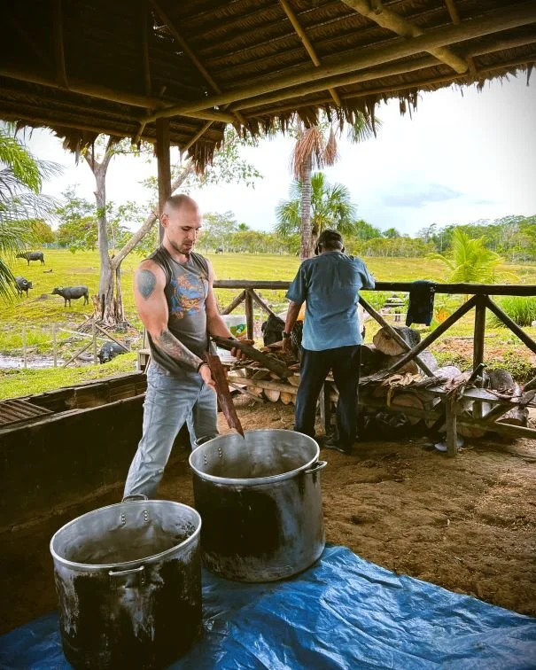 Matt Toussaint places ayahuasca admixture plants into two large cookpots during the ayahuasca cook at Casa del Maestro plant medicine center.