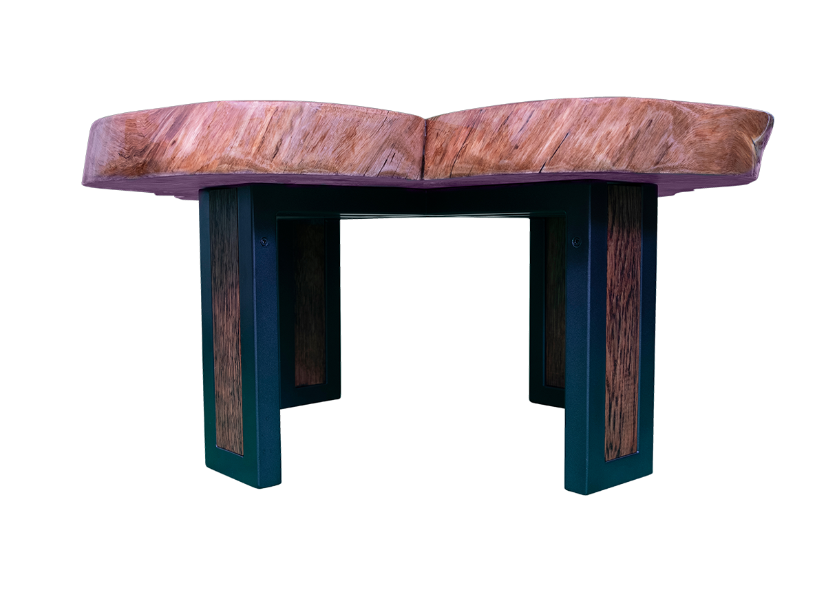 From the plane of the tabletop, the union of elements comes into focus. The raw, crosscut eucalyptus slab resting above a dark metal base, where warmth and structure meet in poised equilibrium.