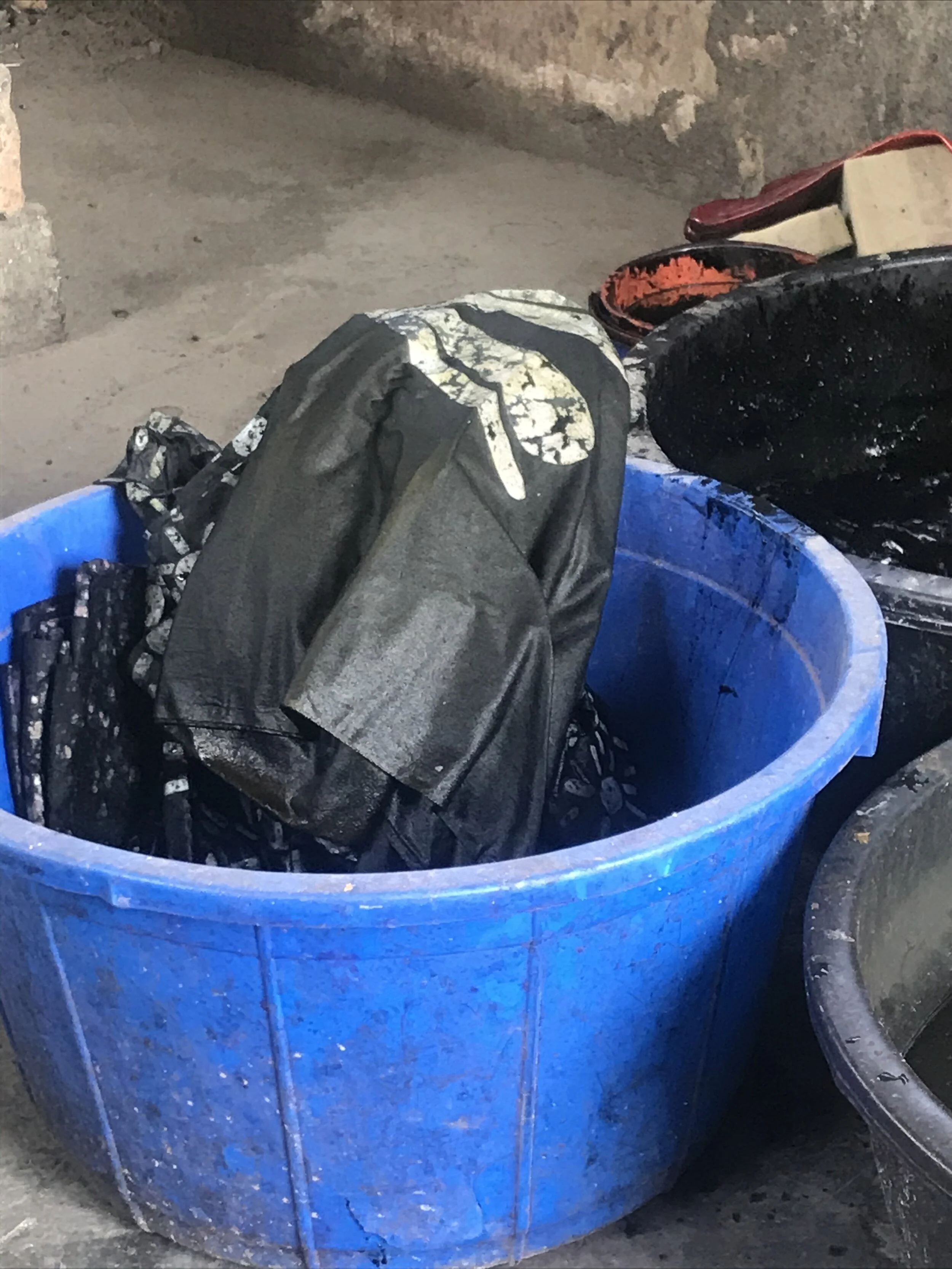 the clitfabric in the making.                                                                           dry wax, freshly dipped in black dye. ready to be hand outside to dry.       Auntie Julie’s workshop, september 2020.