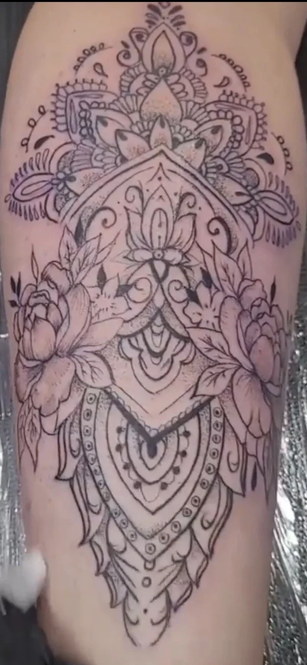 Mandala style tattoo on a female calf