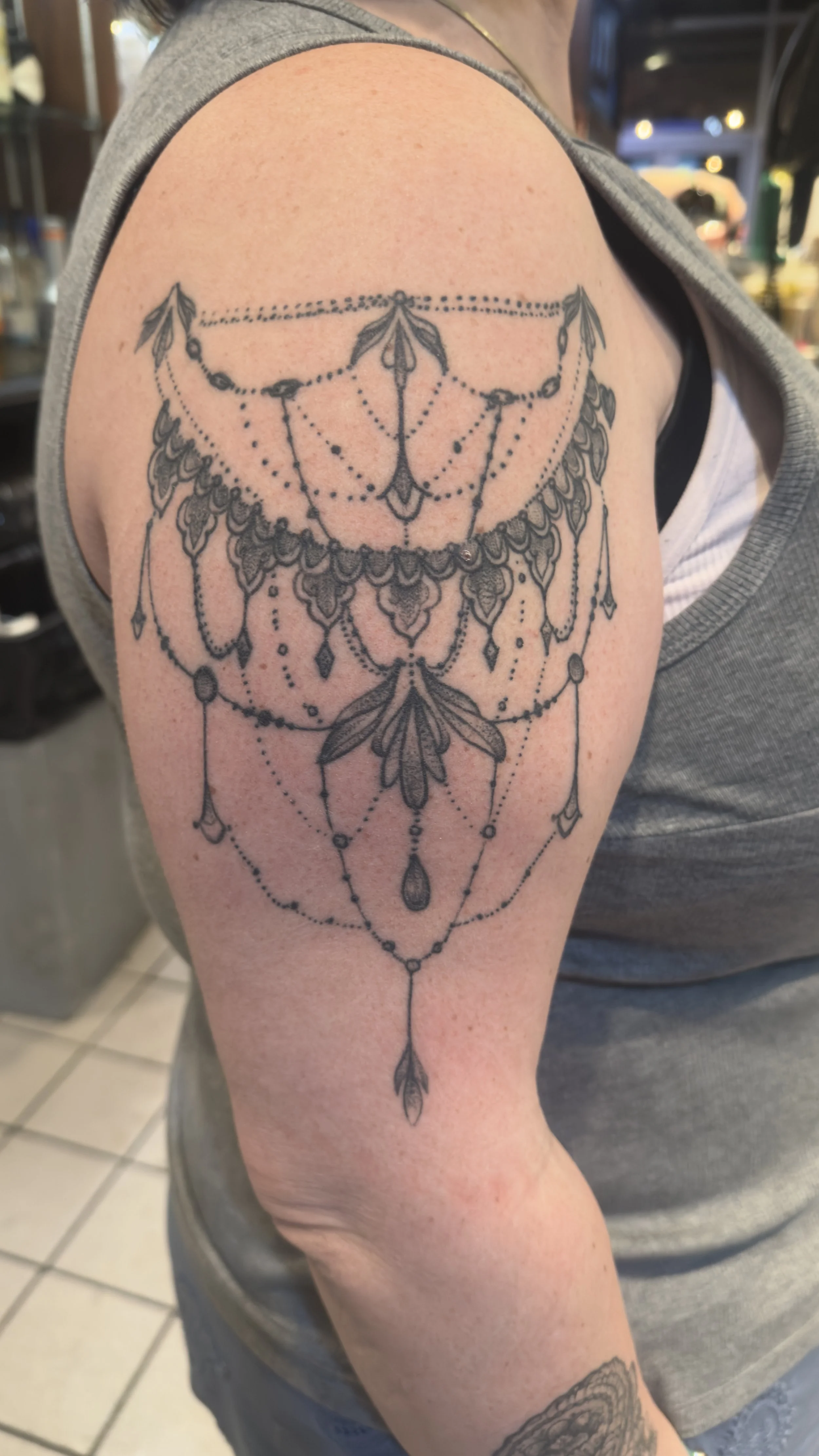 Chandelier style tattoo on a female arm