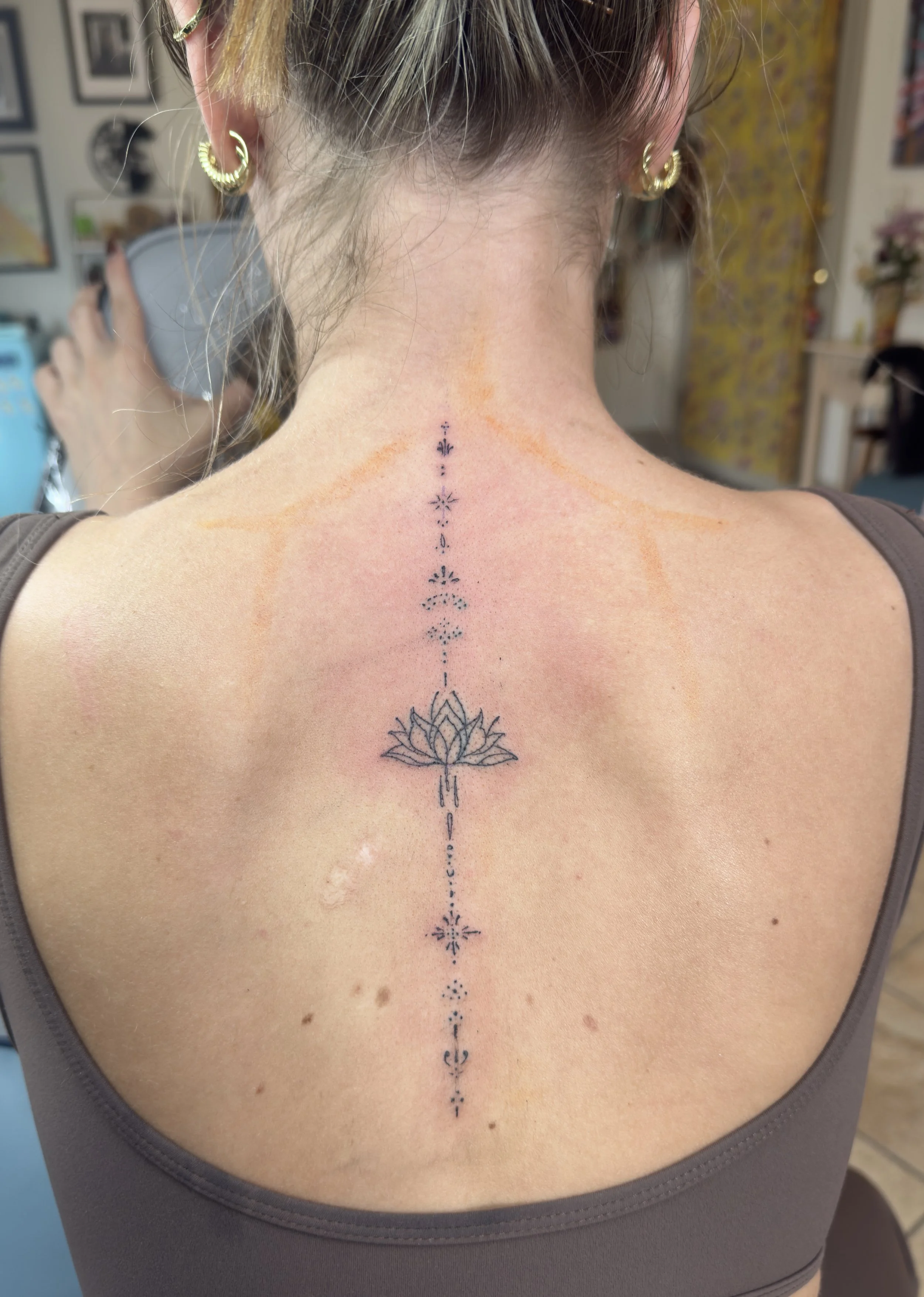Fine line spine tattoo