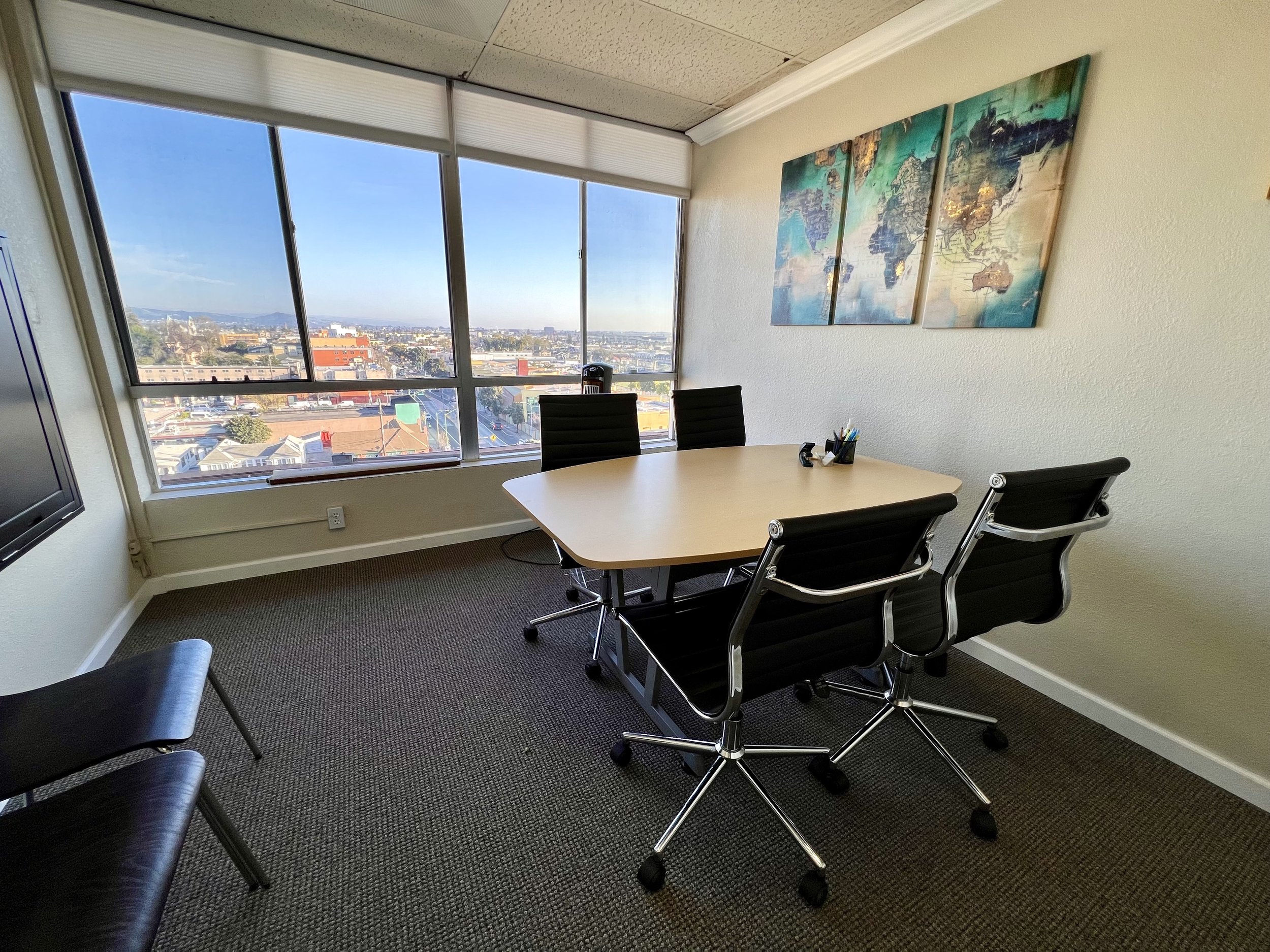 Conference room with table and four chairs - two additional chairs as needed