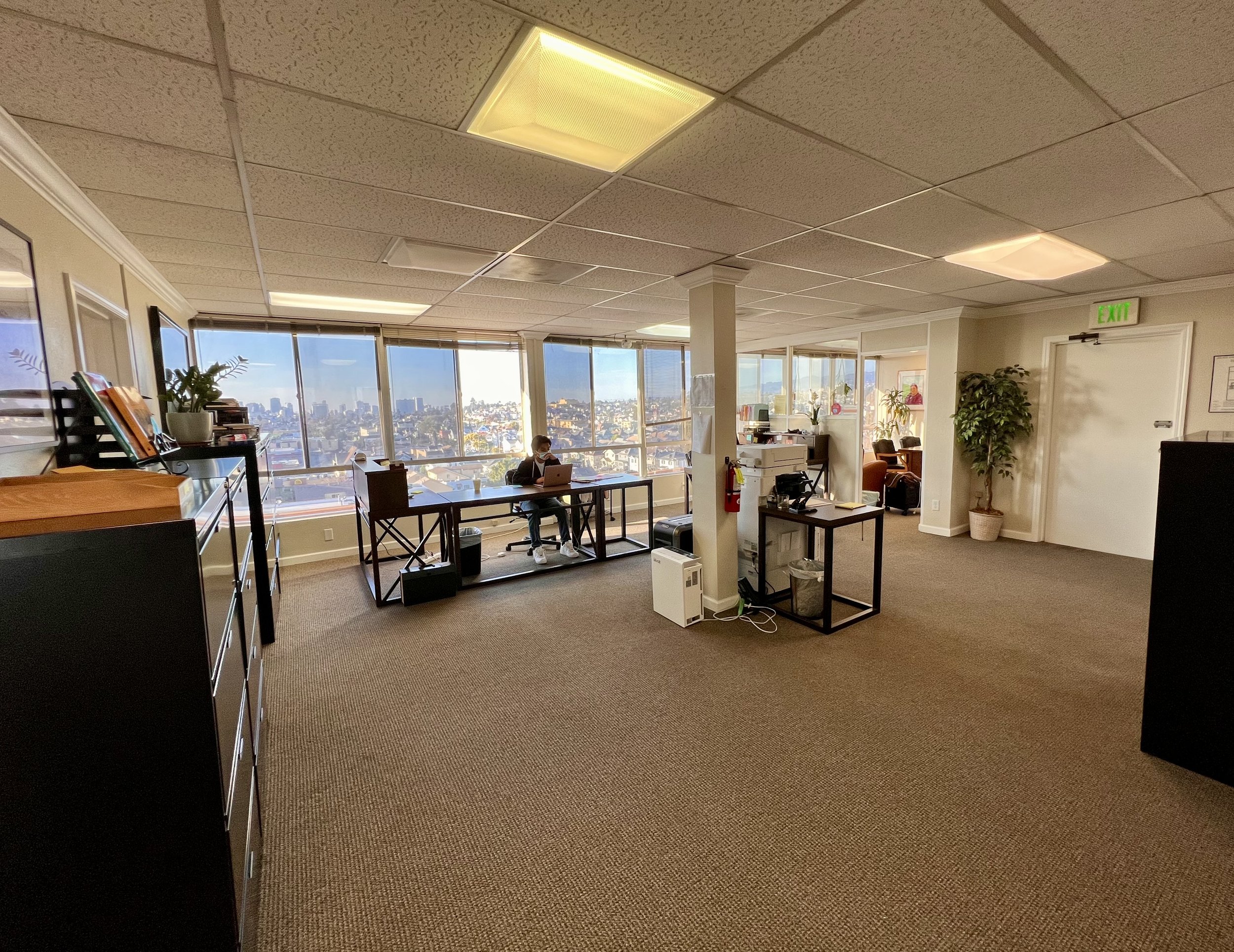 Shot from the reception counter showing two desks and Office C in the far left corner