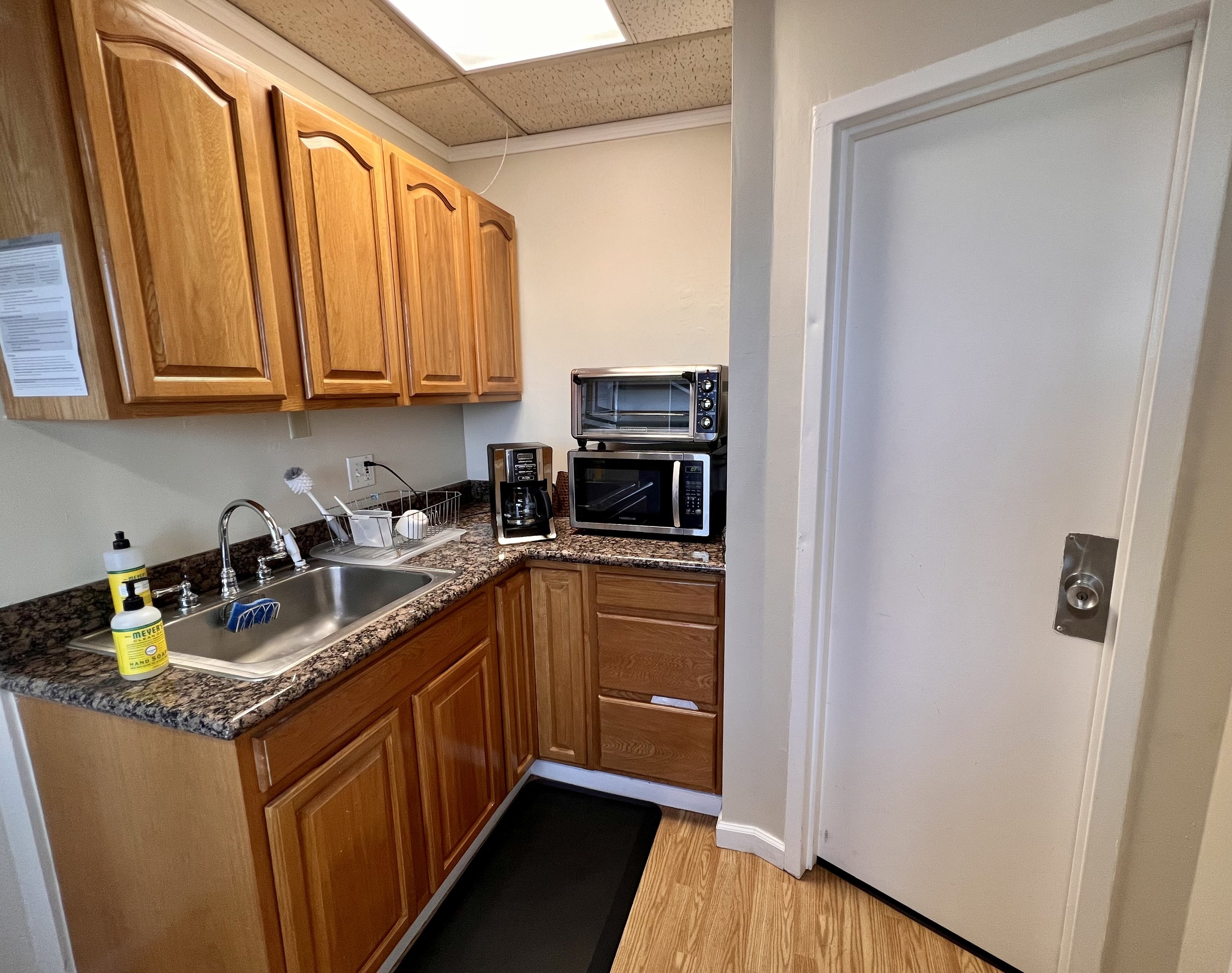 Kitchenette with sink, garbage disposal, coffee maker, microwave, toaster oven, and lots of cupboard space (see next photo for refrigerator, lunch table and shelf space)