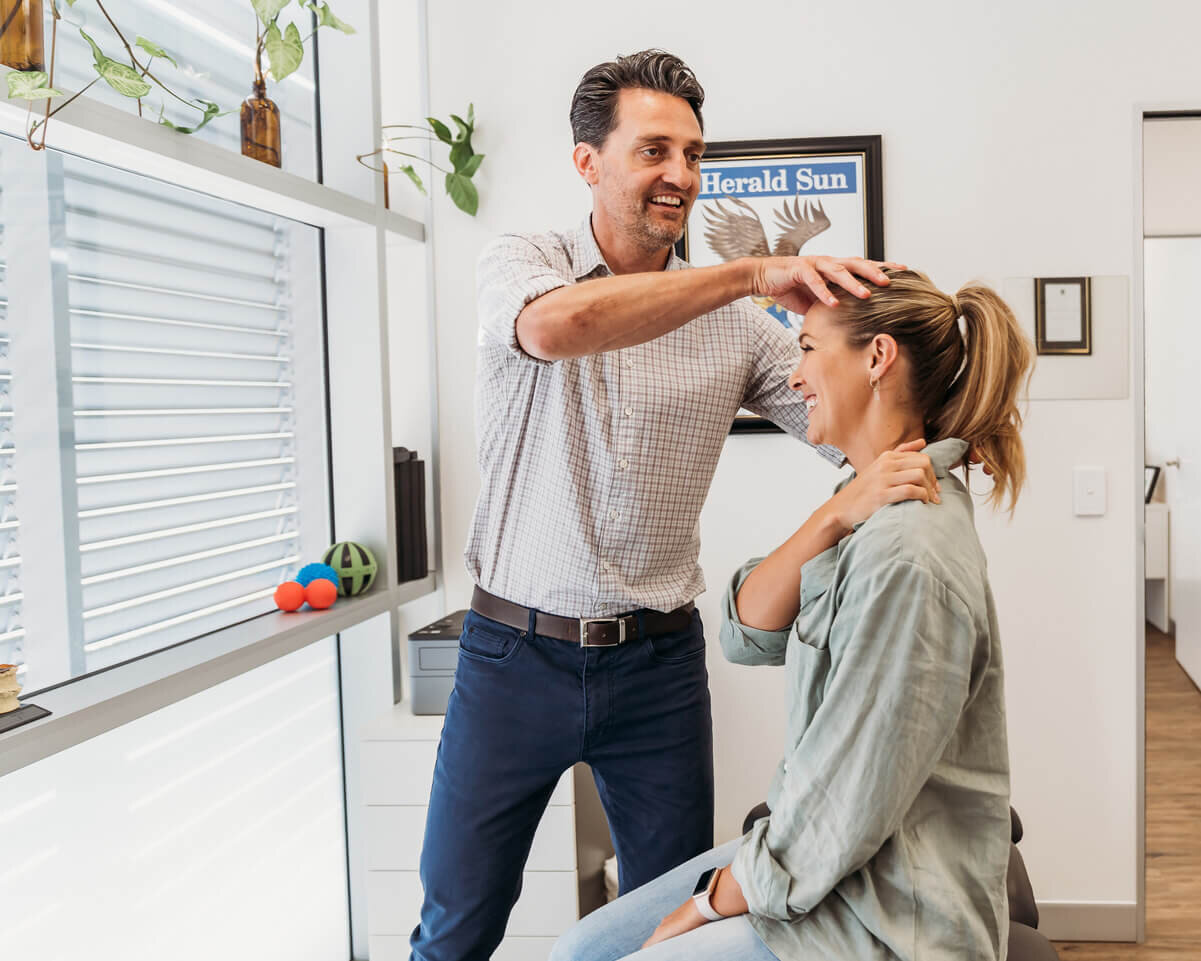 Ben Lawrance treats neck and shoulder pain on a patient in his Capalaba Chiropractic Clinic