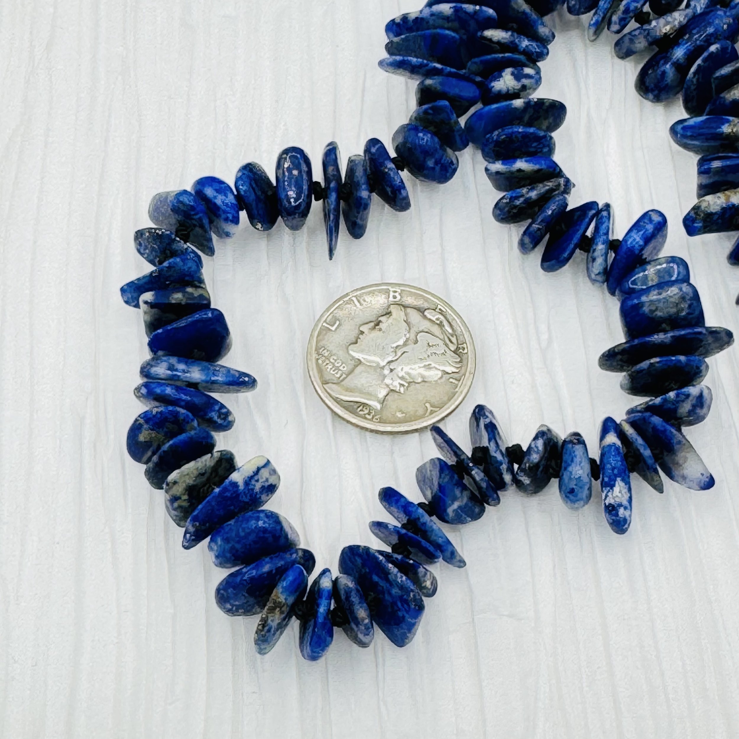 Lapis flat gemstones are hand knotted to create this handmade necklace strand.