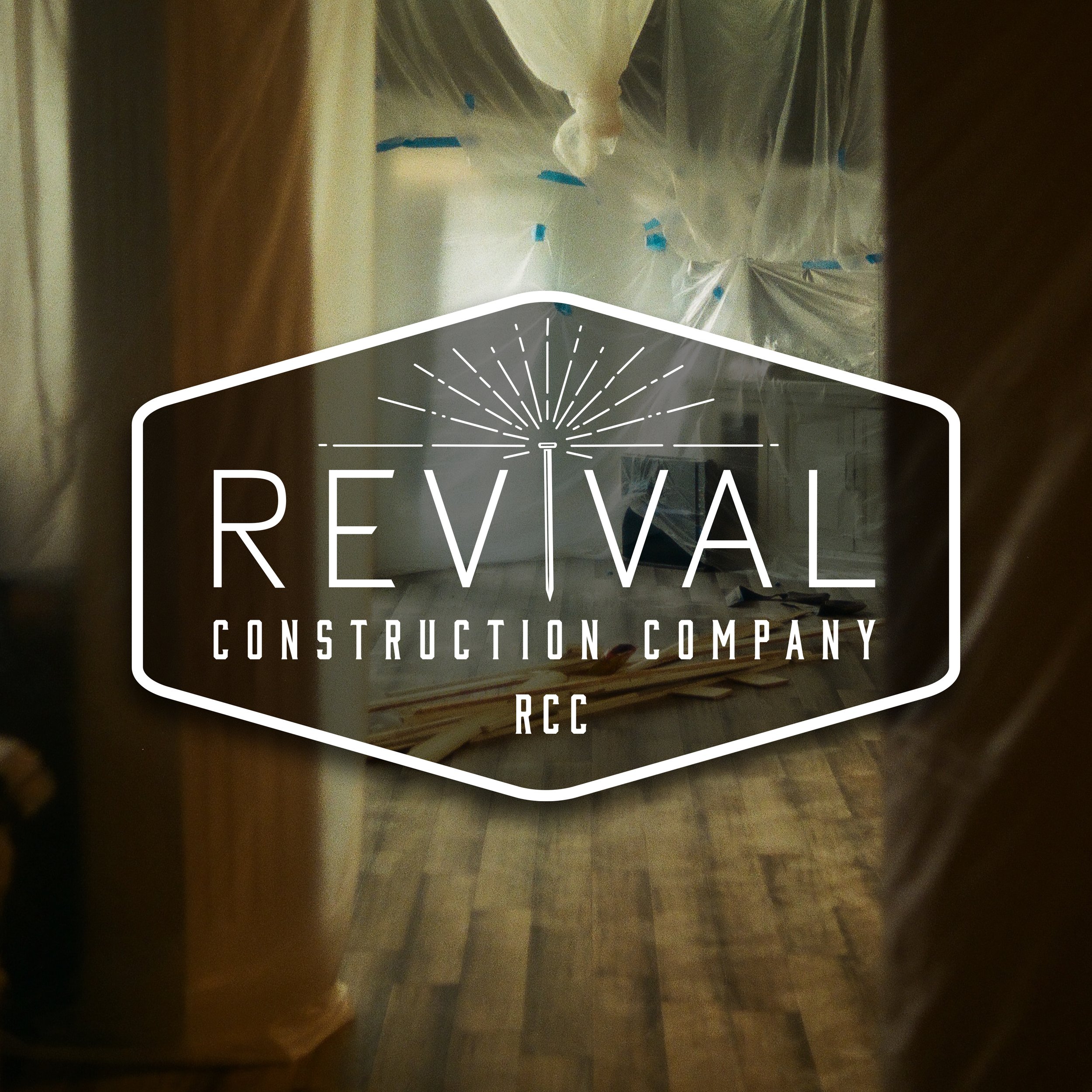 Interior view of a room under construction or renovation, with plastic sheeting covering parts of the ceiling, viewed through a doorway 'REVIVAL logo'.