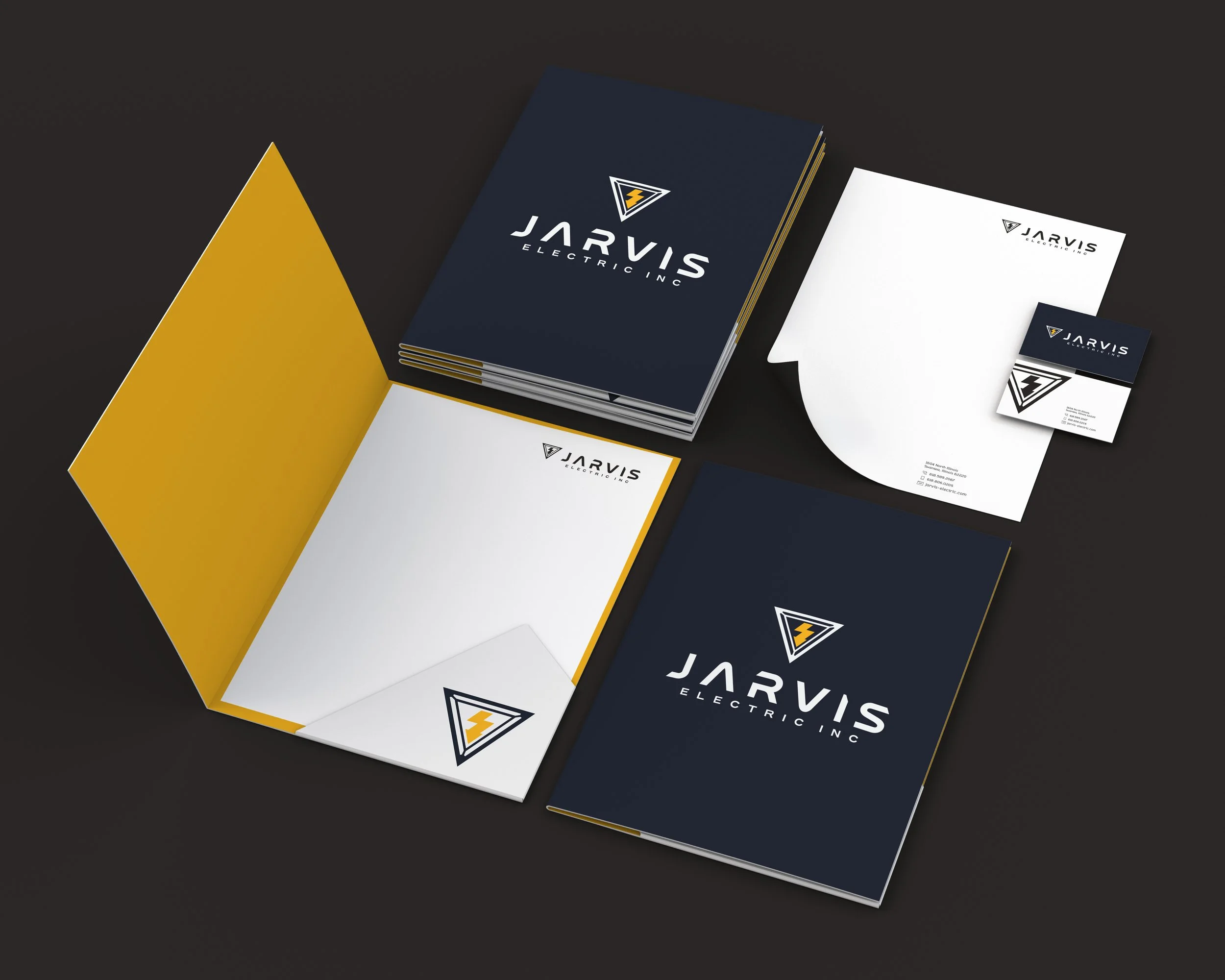 This visual highlights the comprehensive corporate stationery suite developed for Jarvis Electric Inc. to standardize communication and build brand consistency. The premium layout showcases an array of printed office collateral, including a collectio