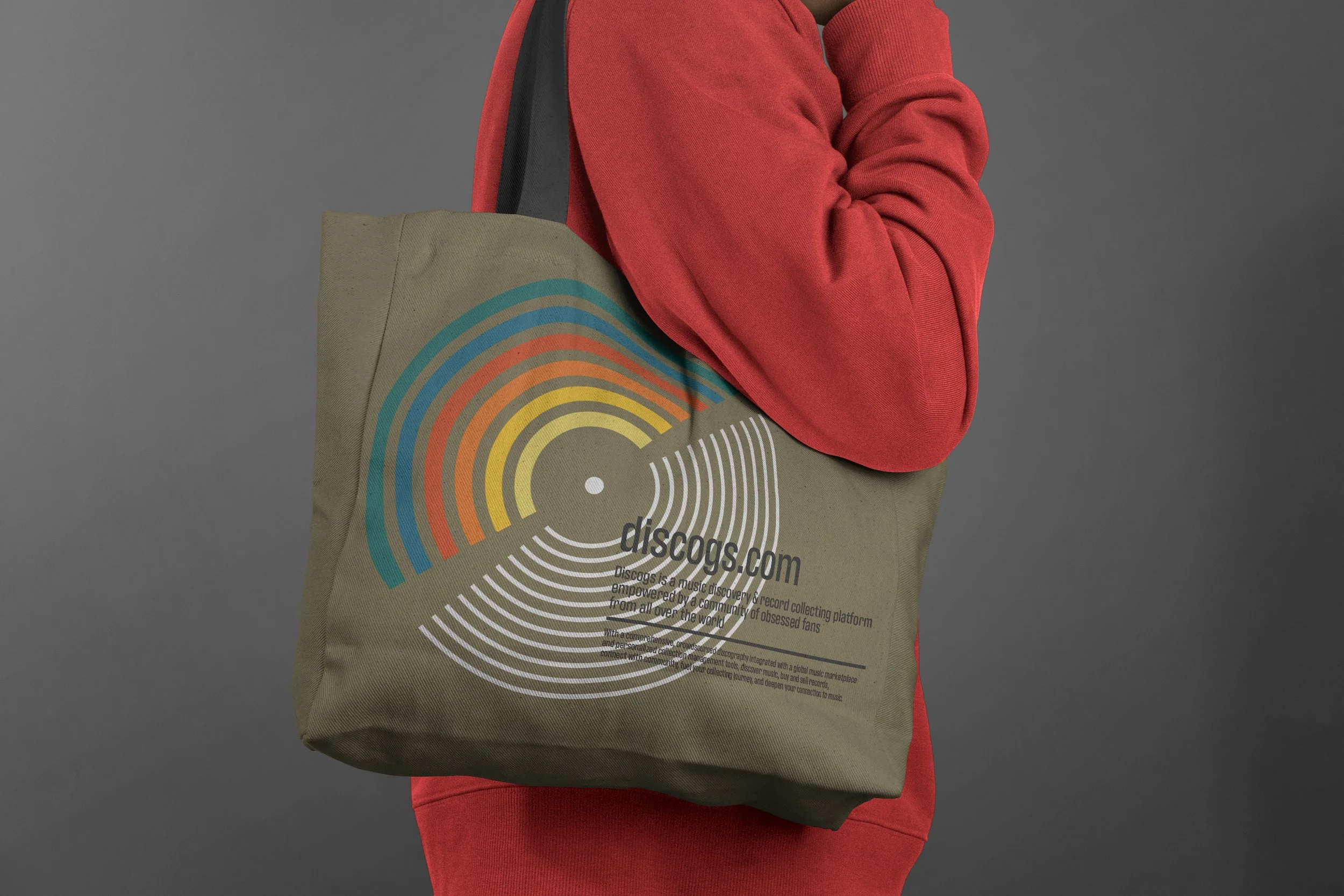 Close up of sage green cotton vinyl record carrying bag featuring retro amber and gold circular record logo for Discogs website store.