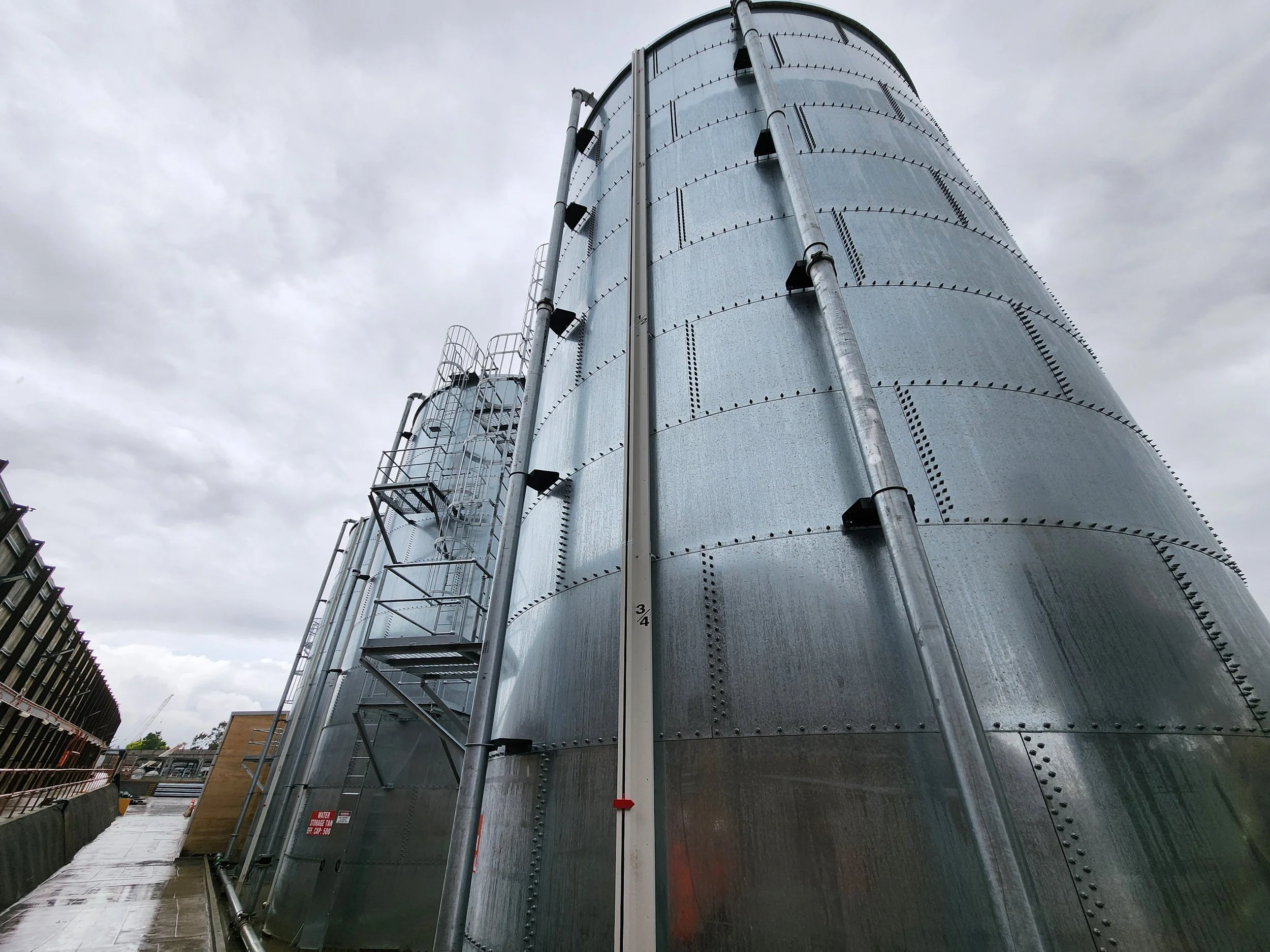 Industrial Water Tank Pipe Support - Project involved routing and support of steel pipe along TBM launch site and to the top of water tanks, without modifying the proprietary tank design.