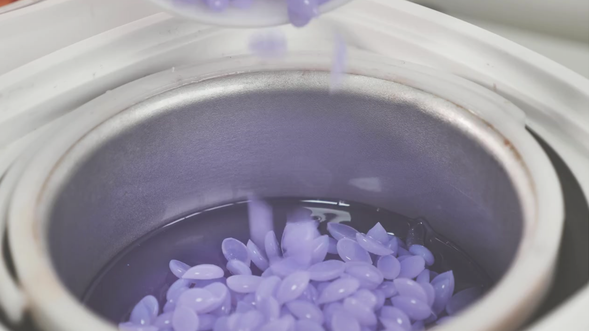 A pot of lilac wax beads
