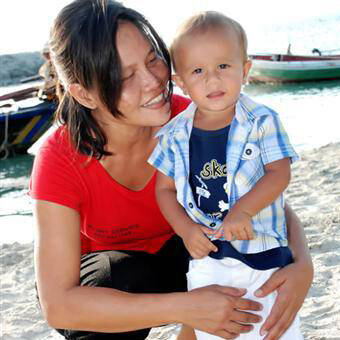 PNA Nanny playing with little boy on beach