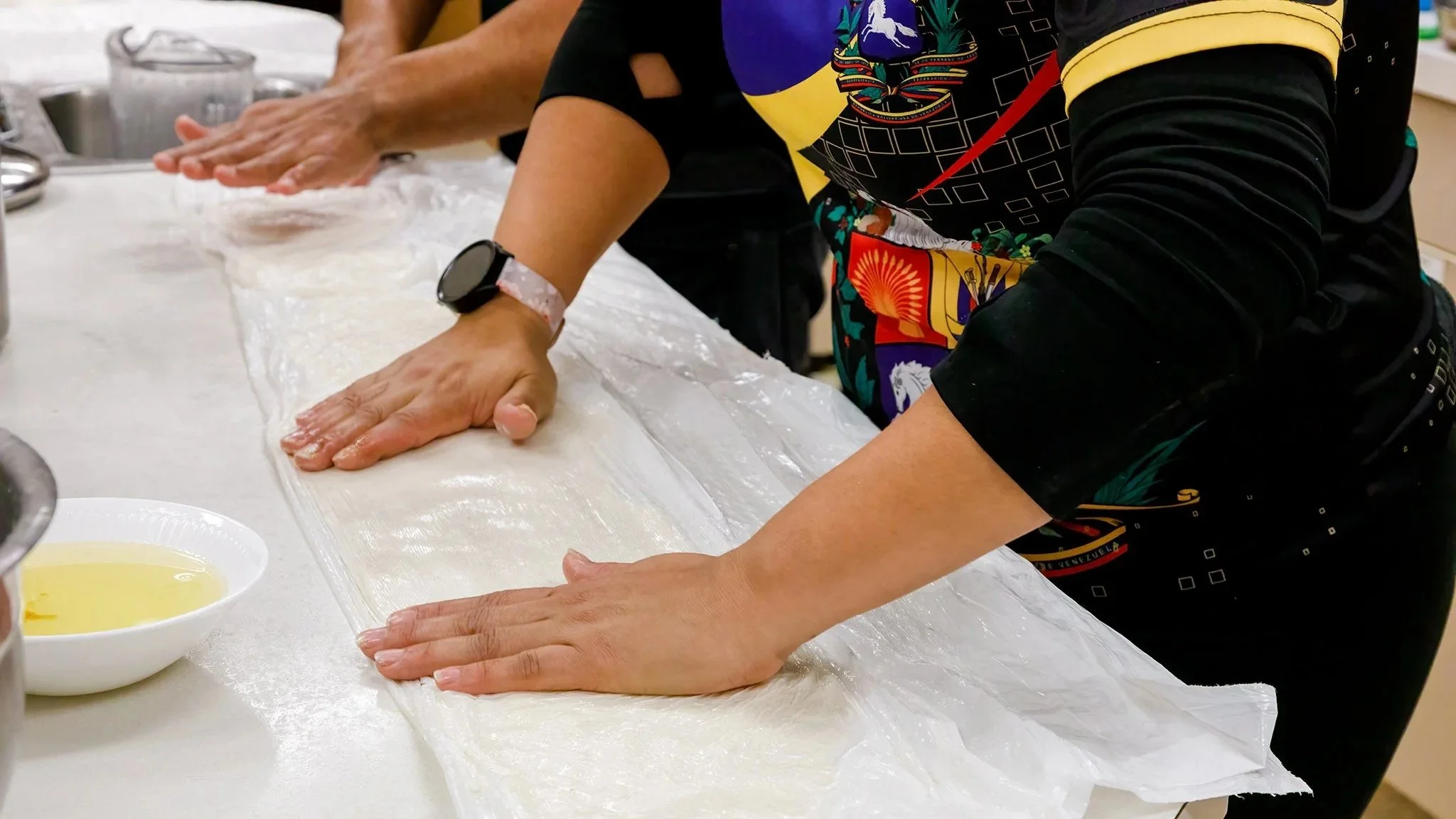 Hands pressing item on countertop for cooking, image by Bob Paulus