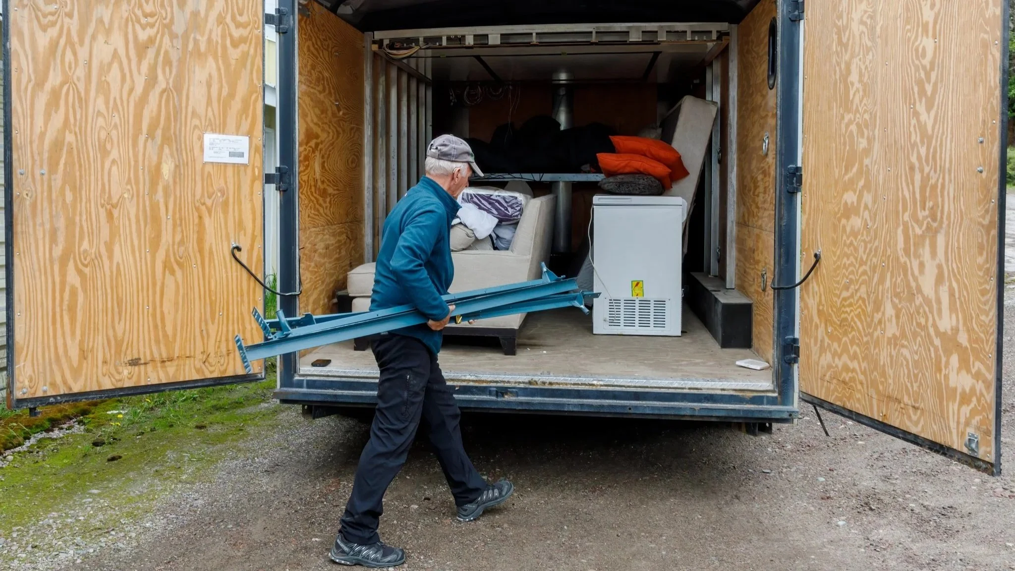 Person carrying items to moving truck.