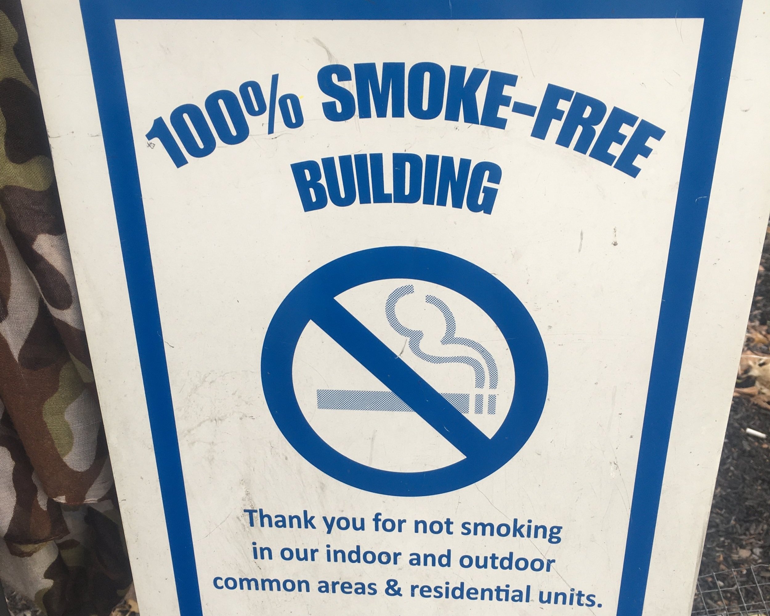   On 99th Street Carver Houses building smoke free; butts outside  