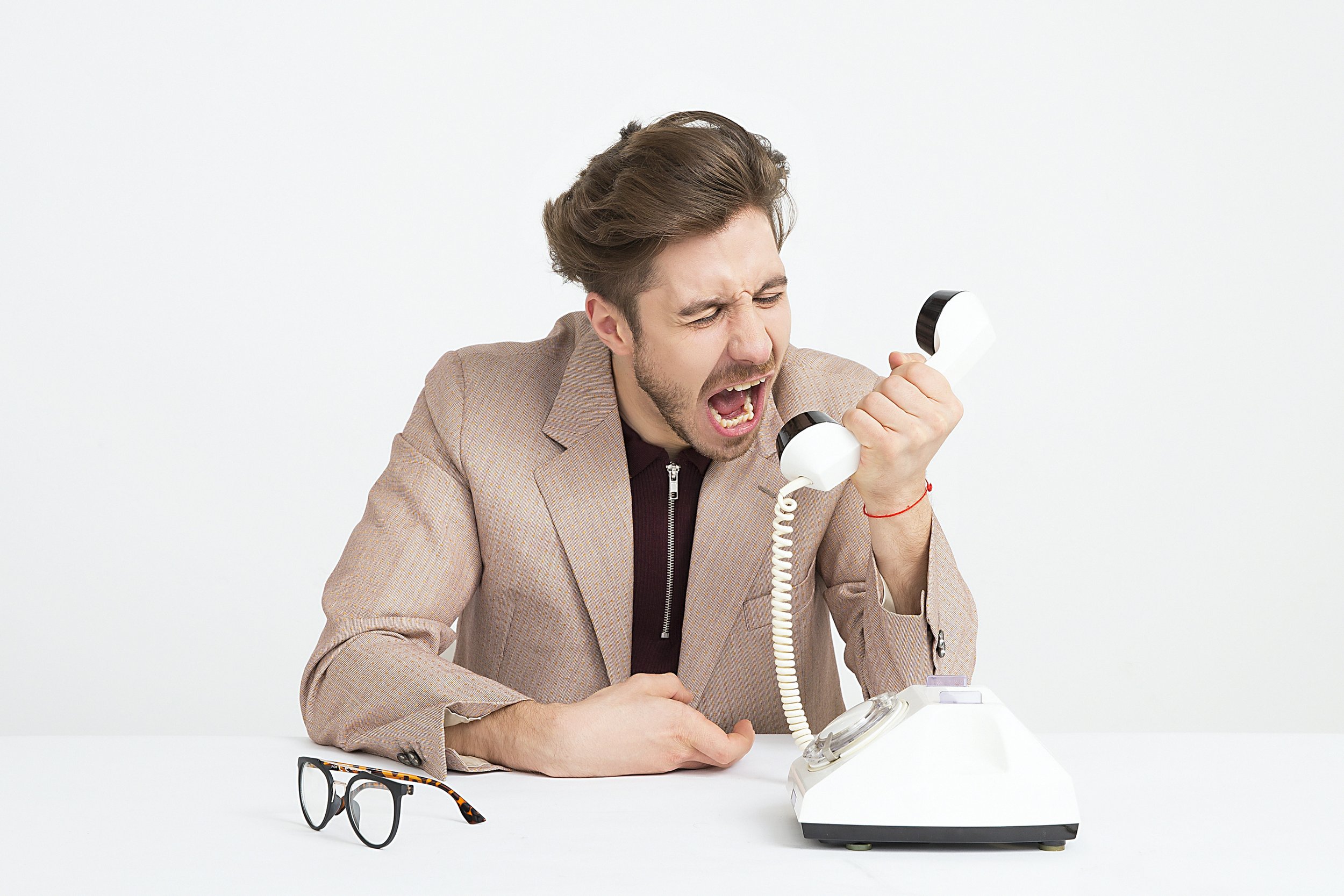 Man menacingly screaming at the phone Stock Photo