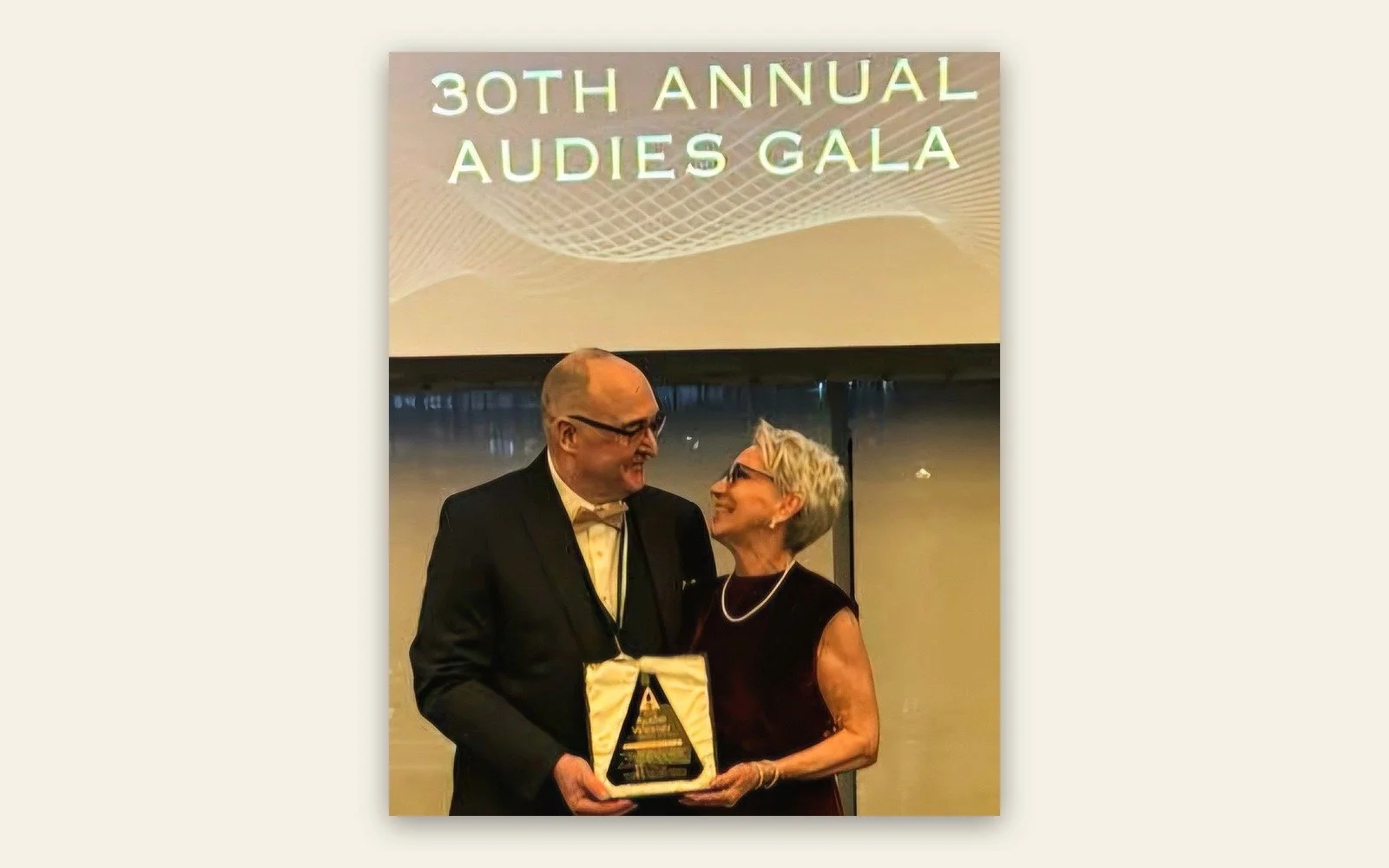 Grant Overstake and his wife Claire holding the Audie Award at the 30th Annual Audies Gala