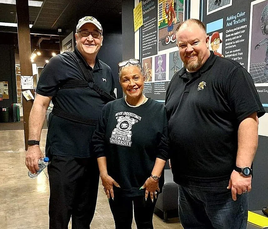 Sheila Brown Kinnard, Grant Overstake and Justin Rorabaugh standing together inside Shocker Studios.