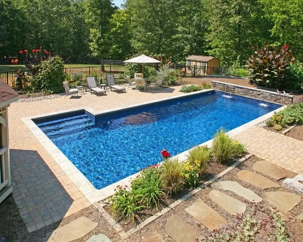 Residential pool service including a rock waterfall feature and diving area
