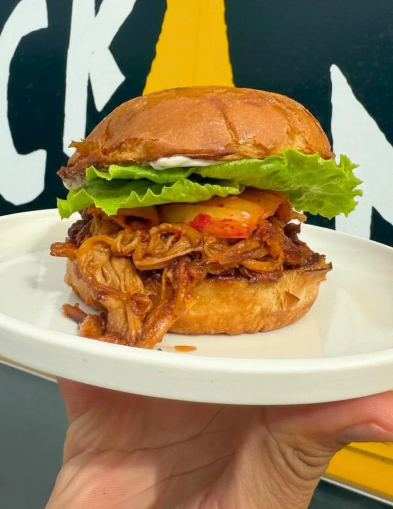 This one&rsquo;s not here to make friends.
The Kimchi Killer is stacked with pulled pork, kimchi, crispy fried onions, and thyme aioli on a brioche bun.
Big flavour. Big bite. No survivors.

The Kimchi Killer was inspired by Chef Paul @a3featherz wan
