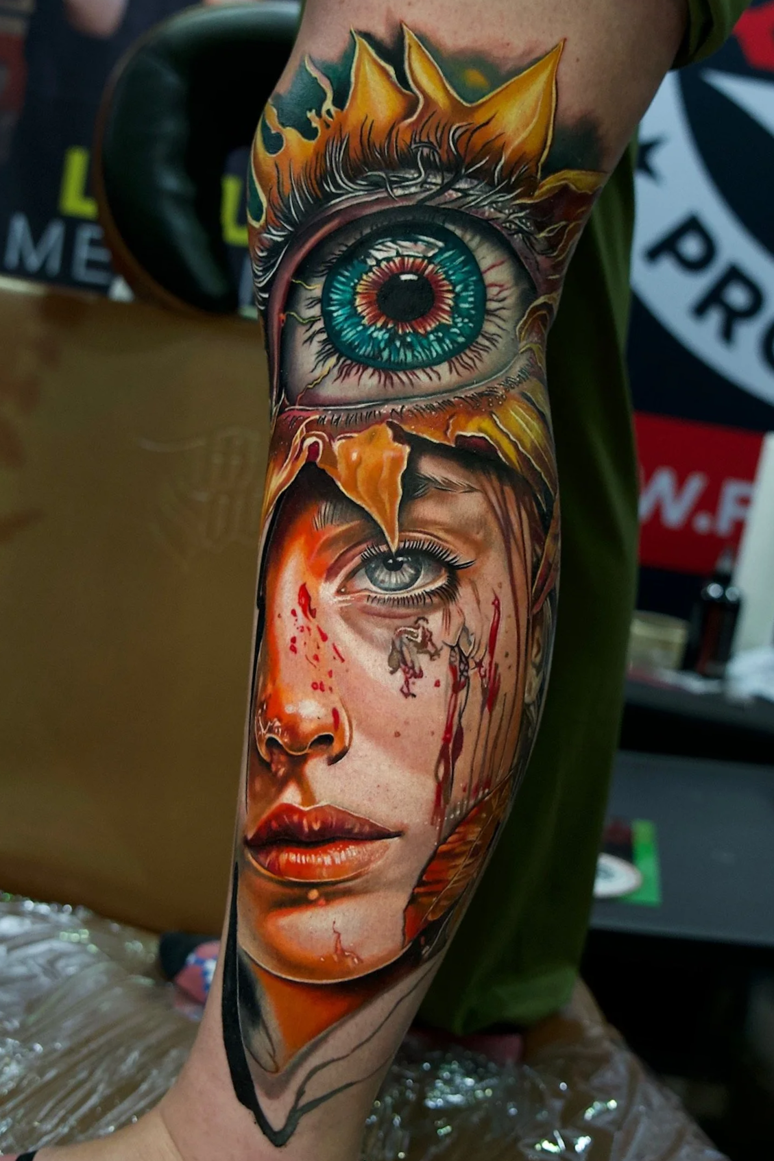 color portrait leg tattoo with a surrealism eye and sunflower