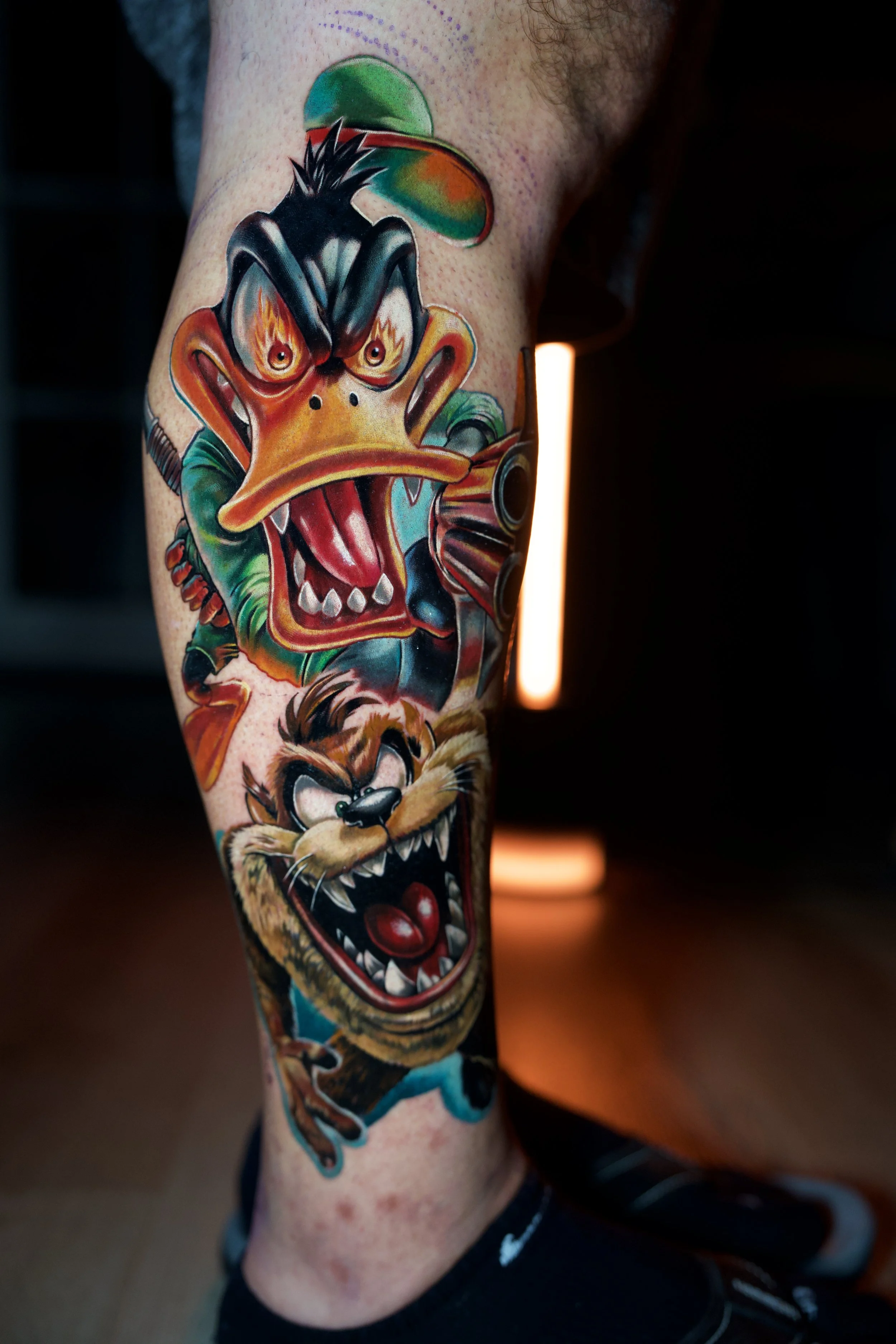 Colorful tattoo of Daffy Duck and the Tasmanian Devil from Looney Tunes. 