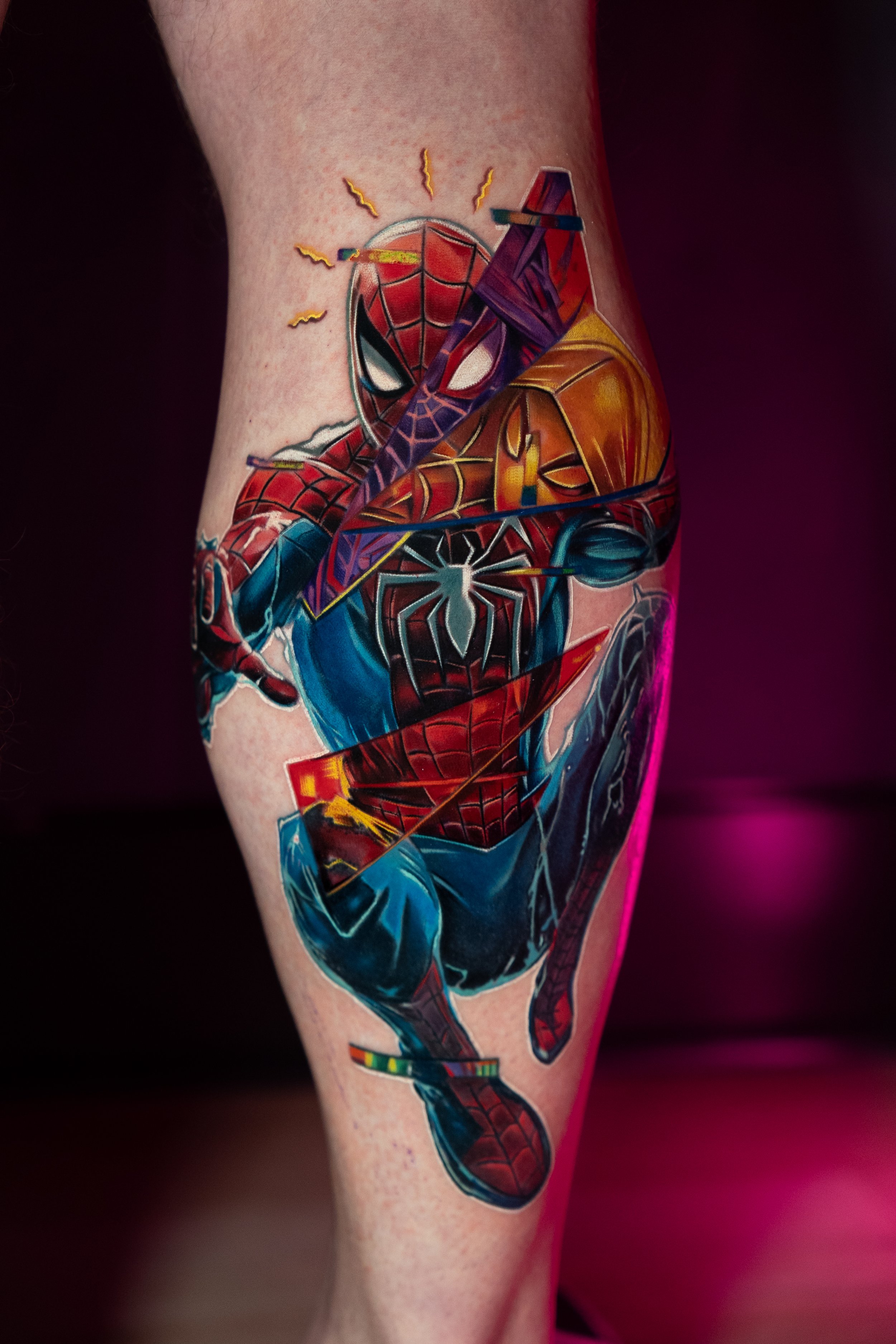 Colored tattoo of Spider-Man in action on person's thigh.
