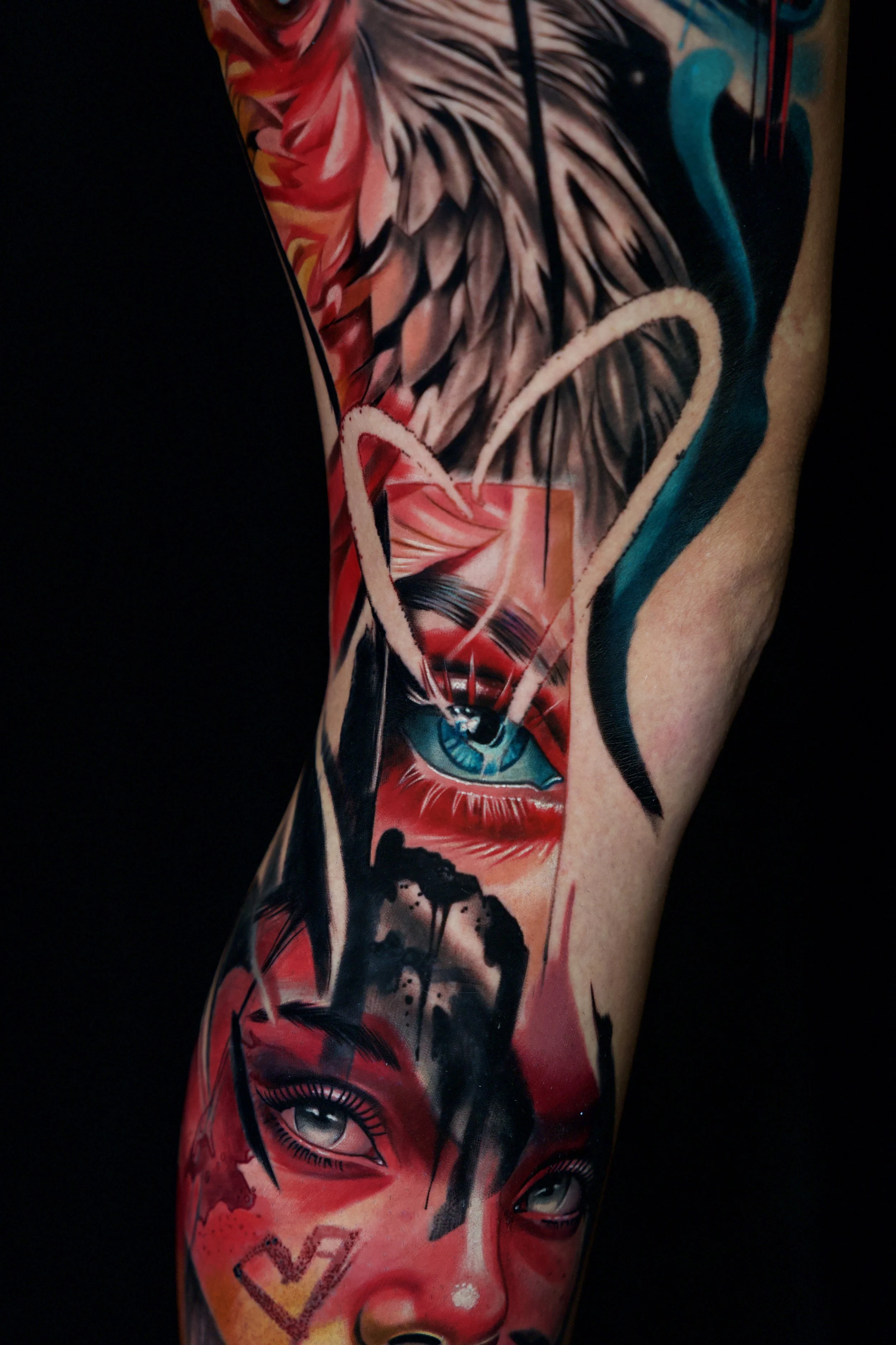 Colorful tattoo sleeve with realistic eyes, abstract shapes, and bold lines.