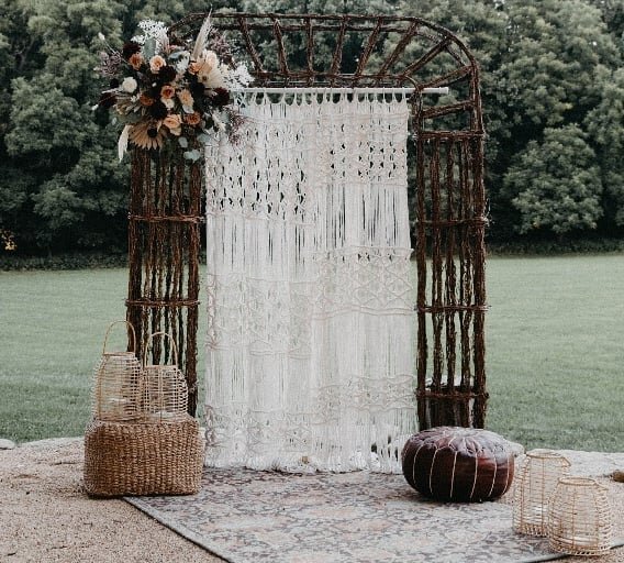 We are loving the boho vibes in this photo! Our stick arbor paired with macrame curtians, leather and jute poufs, and a bohemian style rug to tie it all together. 
.
.
Photography  @hailiwise
Venue  @thebarnatriverbend
Floral  @paiges.petals
Rentals 
