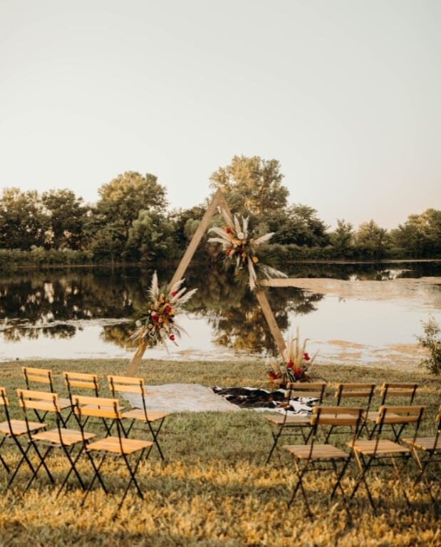 Our triangle arbor and wood and metal folding chair are perfect for any outdoor ceremony. 
.
.
Publication: @wed.kansascity
Photography: @sarahdeanphoto
Planning &amp; Coordination: @dana.ashley.events
Floral: @bergamotandivykc
Venue: @regalhillsvenu