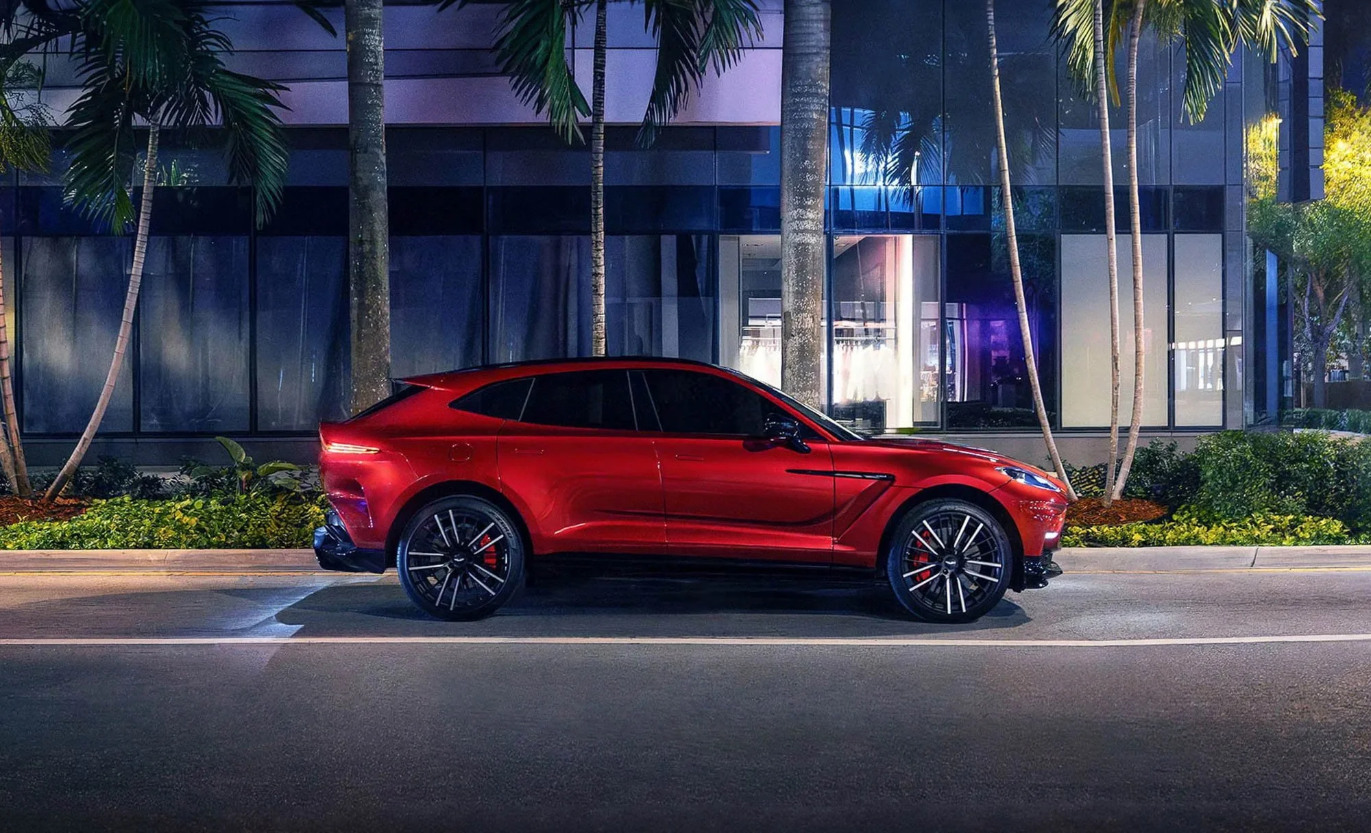 Aston Martin DBX luxury SUV photographed at night in Brickell, capturing cinematic urban lighting and premium automotive imagery by commercial photographer David Masemore.