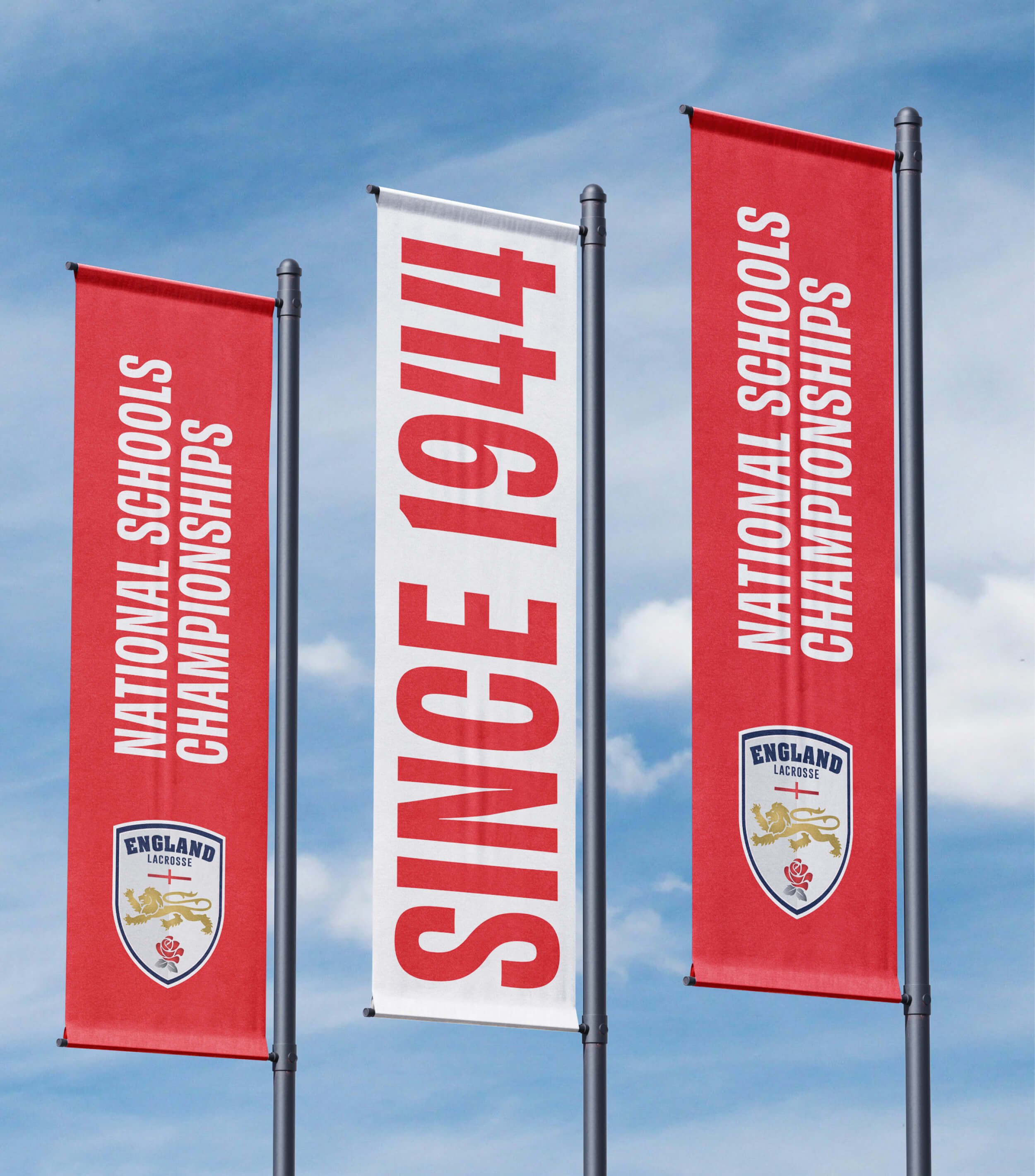 National Schools Championships banner flags against a blue sky.