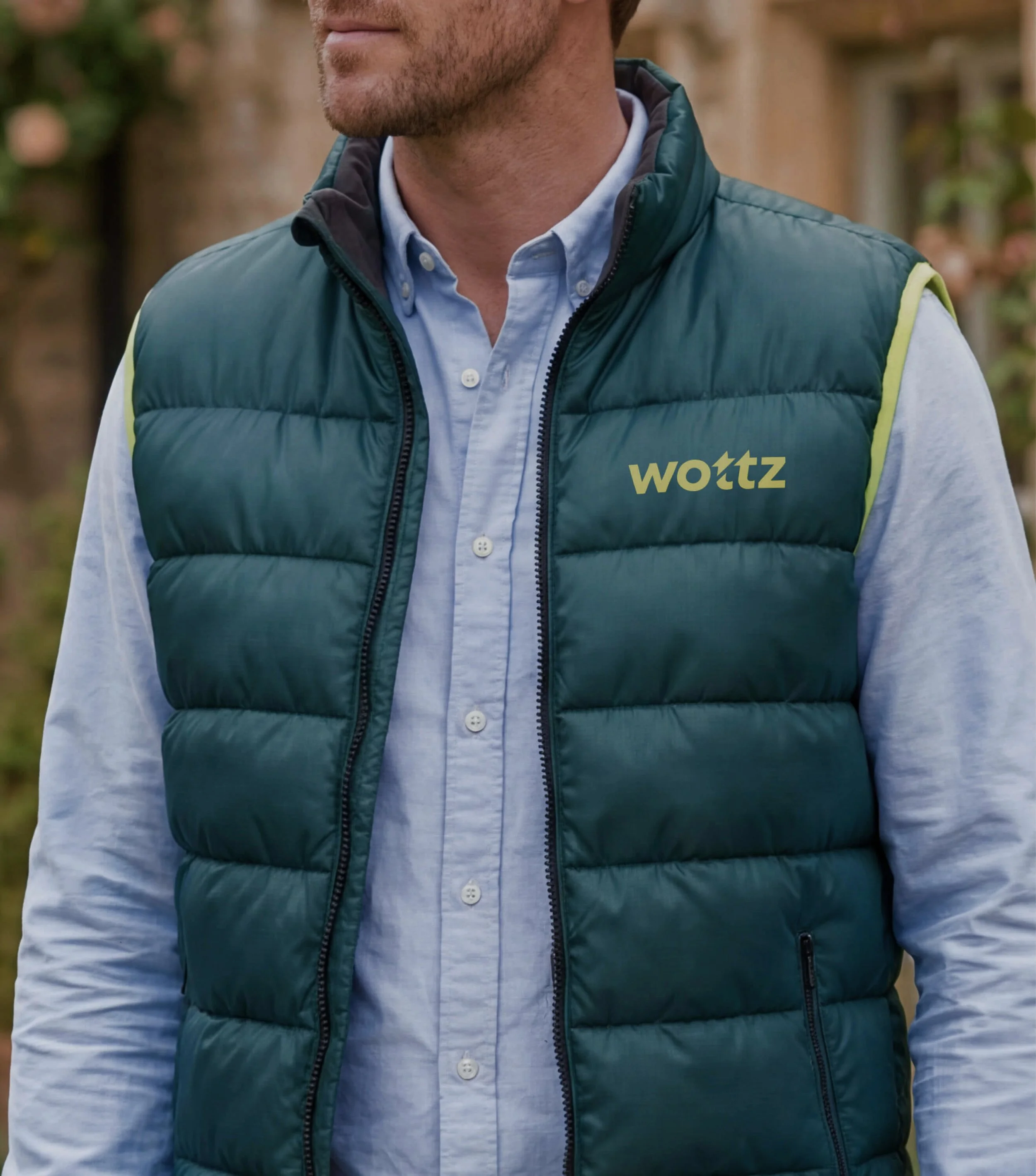 Wottz logo on a branded dark teal gilet.