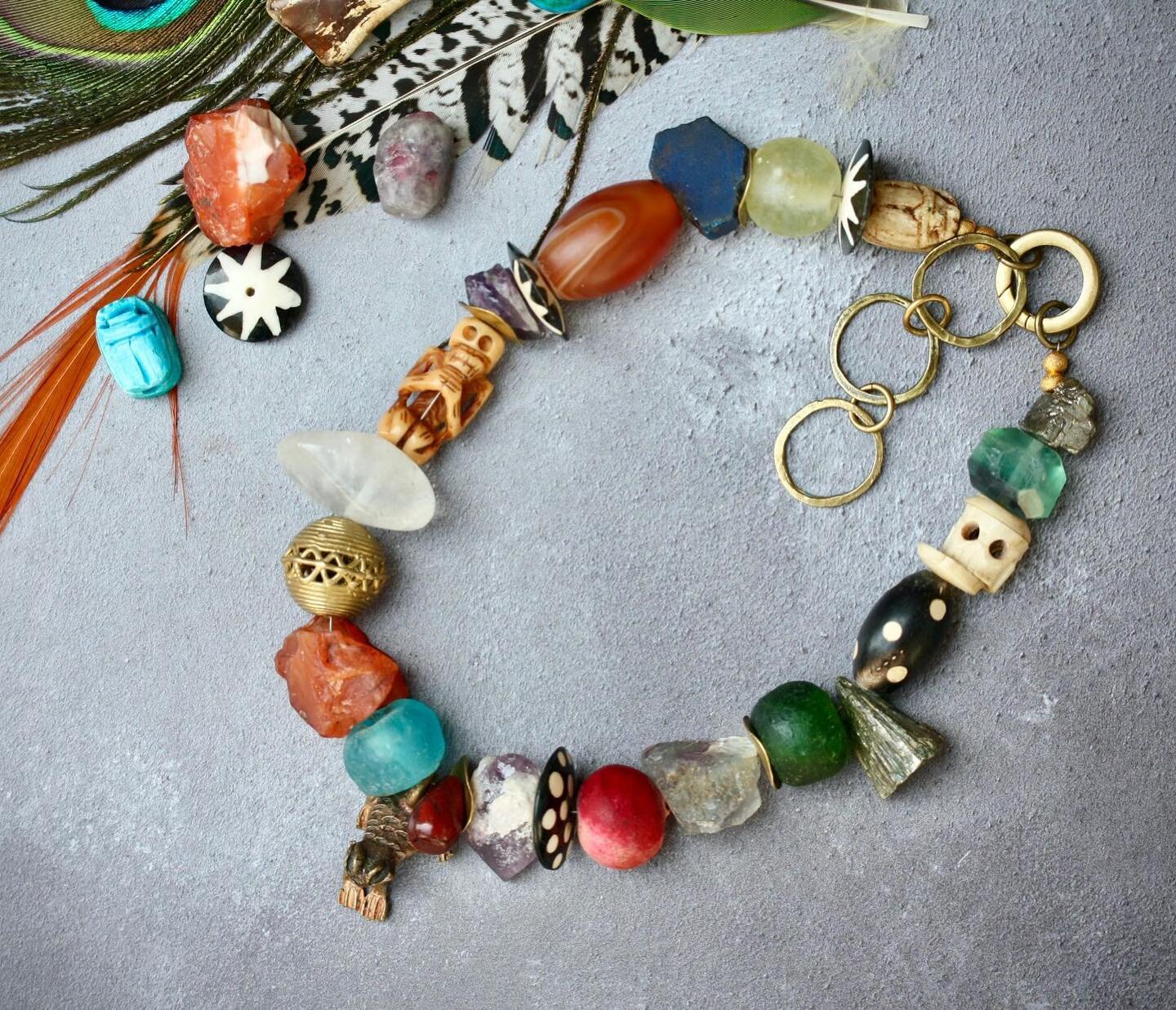 This bohemian statement necklace is crafted from found and handmade pieces by our @palomita_jewellery . They include recycled glass beads, Yak bone skulls, large Peruvian seed pods, semi-precious stones such as amethyst, Fluorite, carnelian and a han