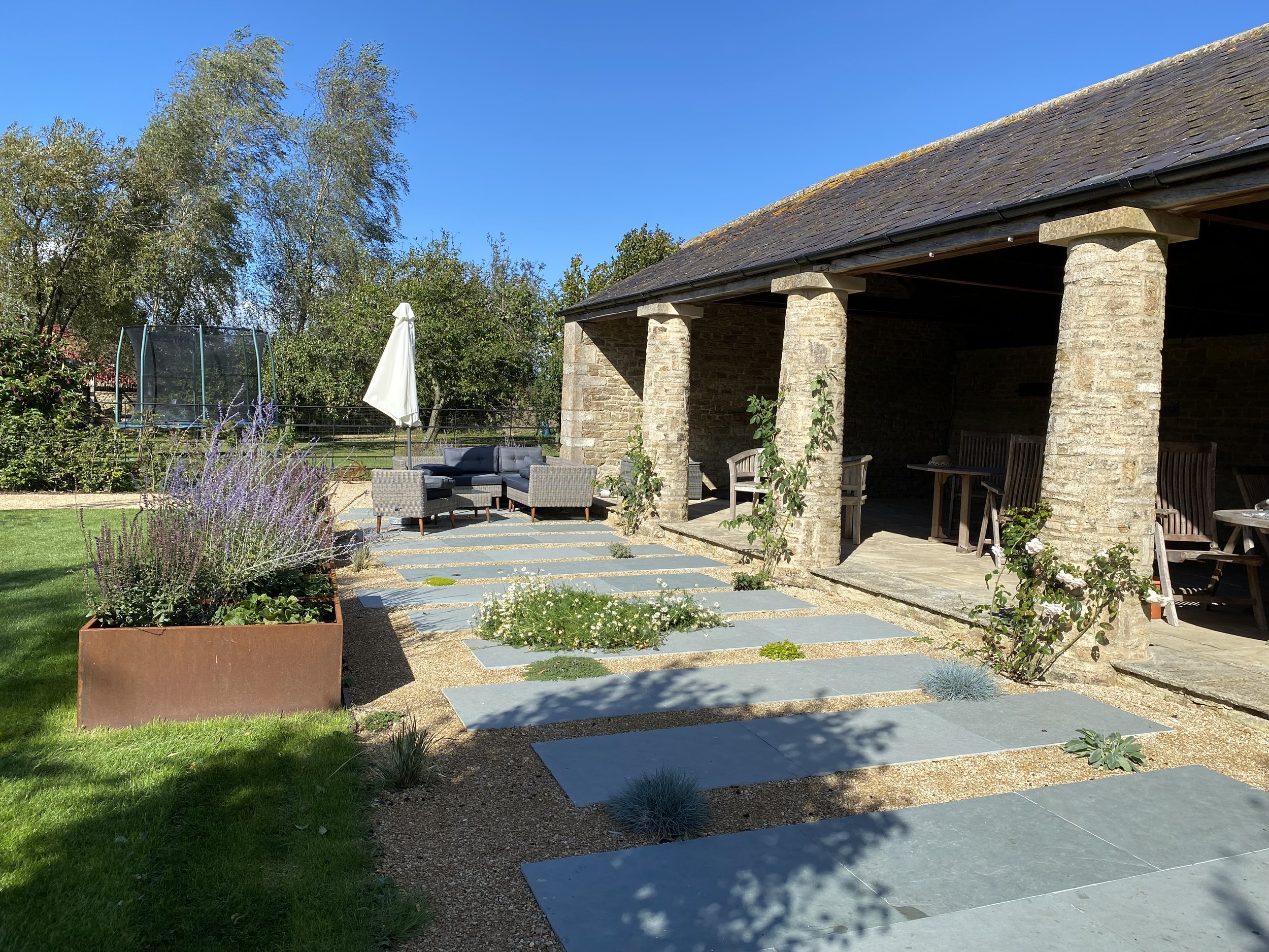 Contemporary paving to contrast with the Cotswold Barn
