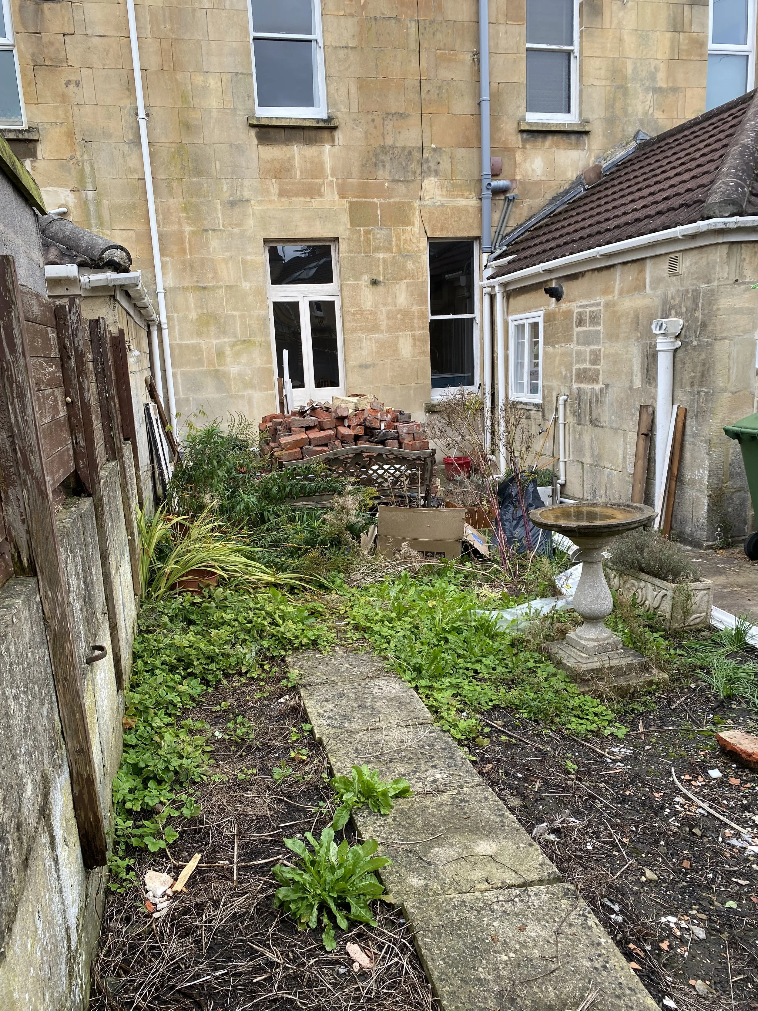 Before - house bricks to be laid into a new patio in a basket weave pattern
