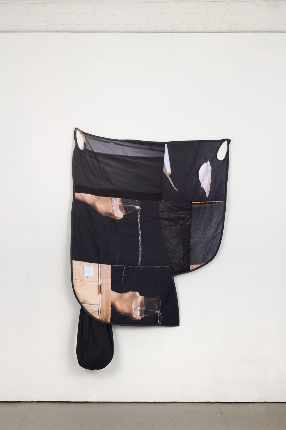 'Spill' (2022), photographs printed on fabric, old clothes, cut, pieced, and sewn, cotton batting, polyester filling, 62” x 40” x 8”