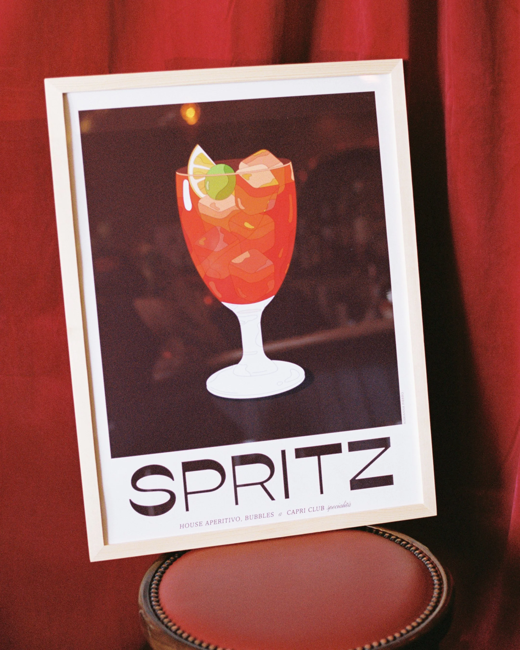 Capri Club Spritz print displayed in bar setting — collectible Italian cocktail illustration print design