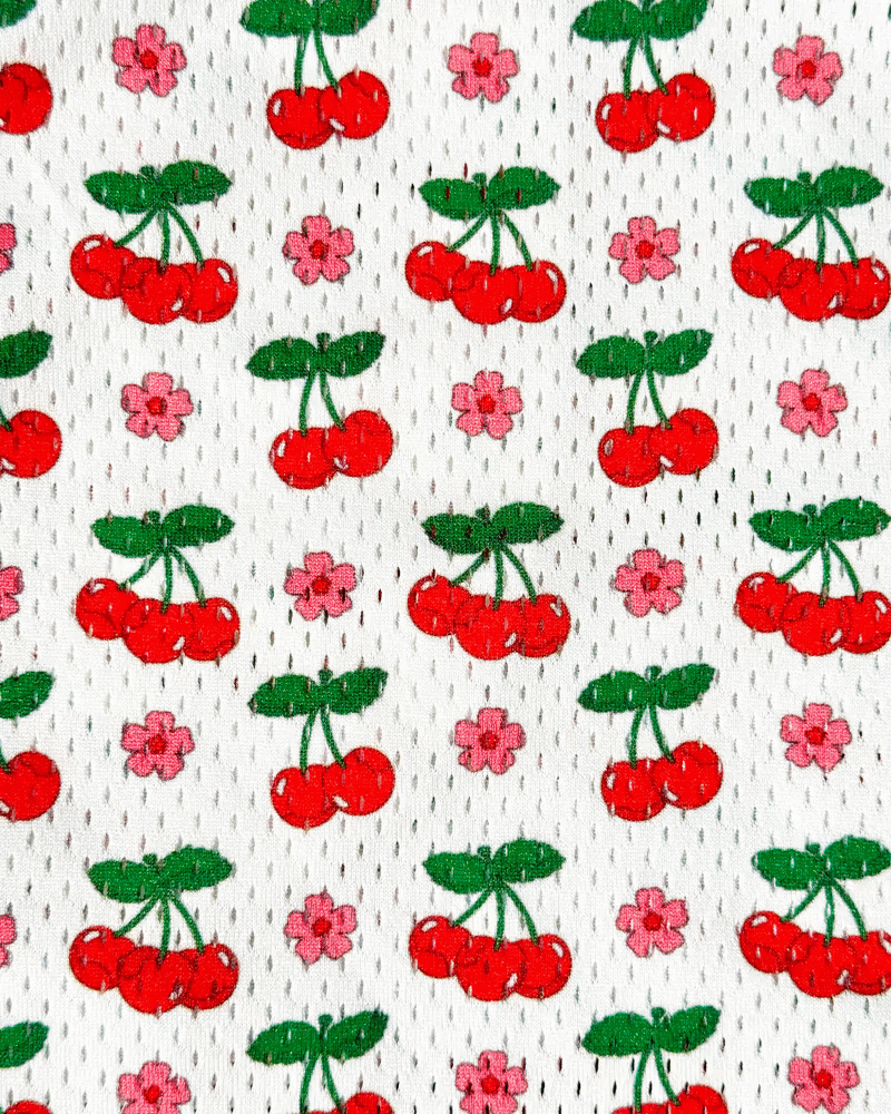 Italian Summer Lax Shorts — cherry and floral print design by Marianna Fierro for Relax Lacrosse, shown in detail and on-body.