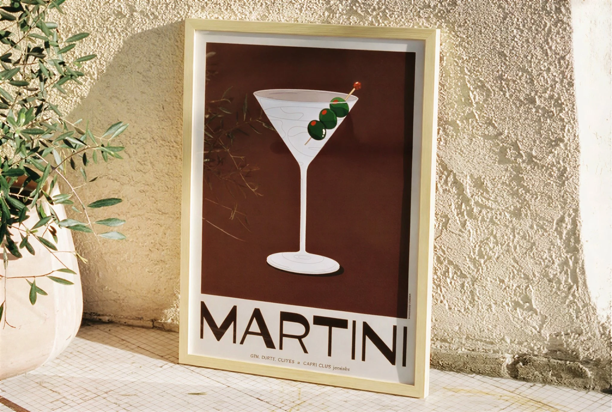 Capri Club Martini print leaning against outdoor wall — collectible cocktail illustration for Los Angeles aperitivo bar