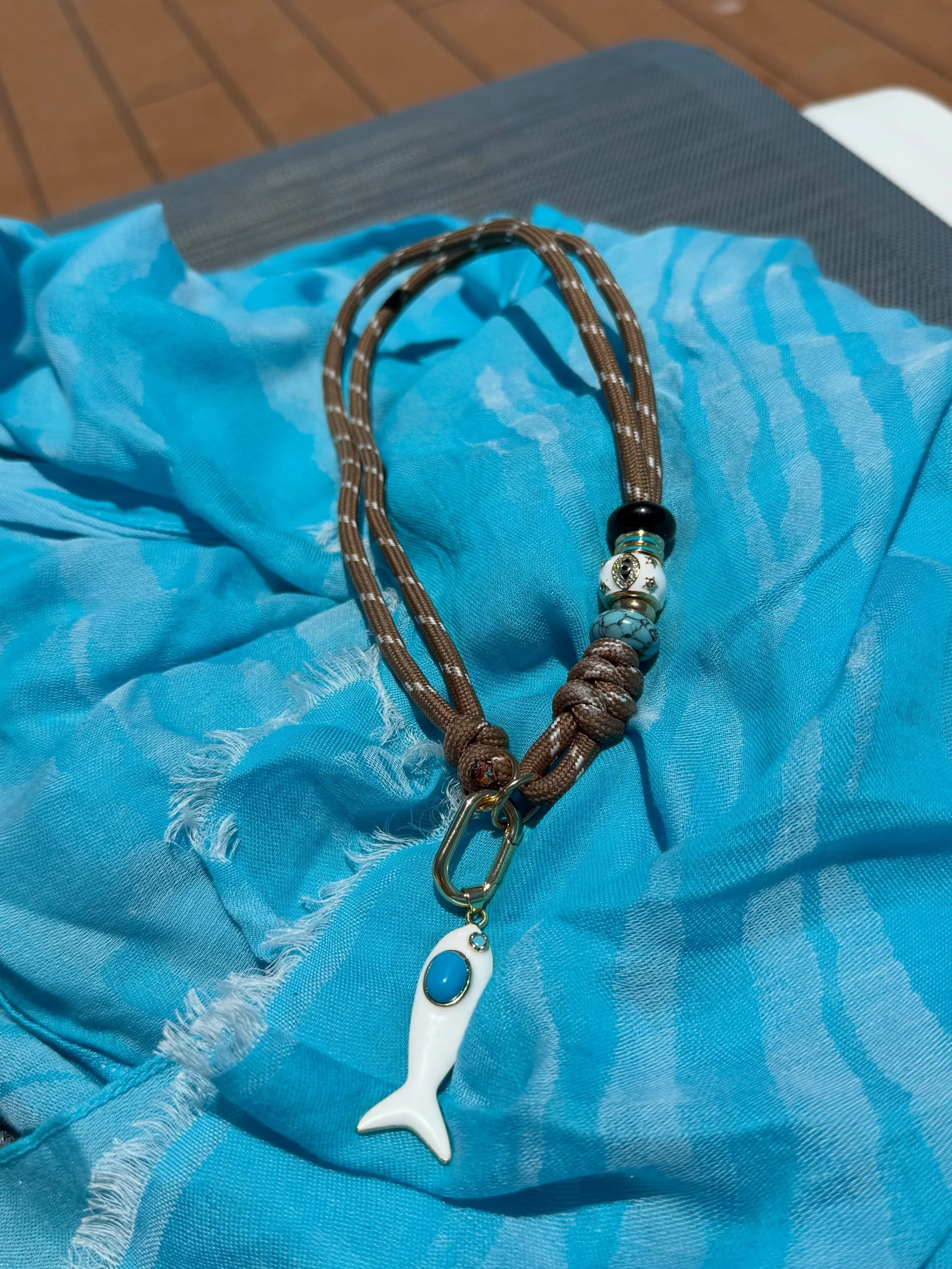 Happy Fish Cord Necklace 🎏🎣🌊 Catch of the day 🐟✨ in every color!!

Handmade 16&rdquo; cord necklace, 18k gold plated spacers, natural stone donut spacer beads and 1.45&rdquo; enamel fish detachable pendant.
